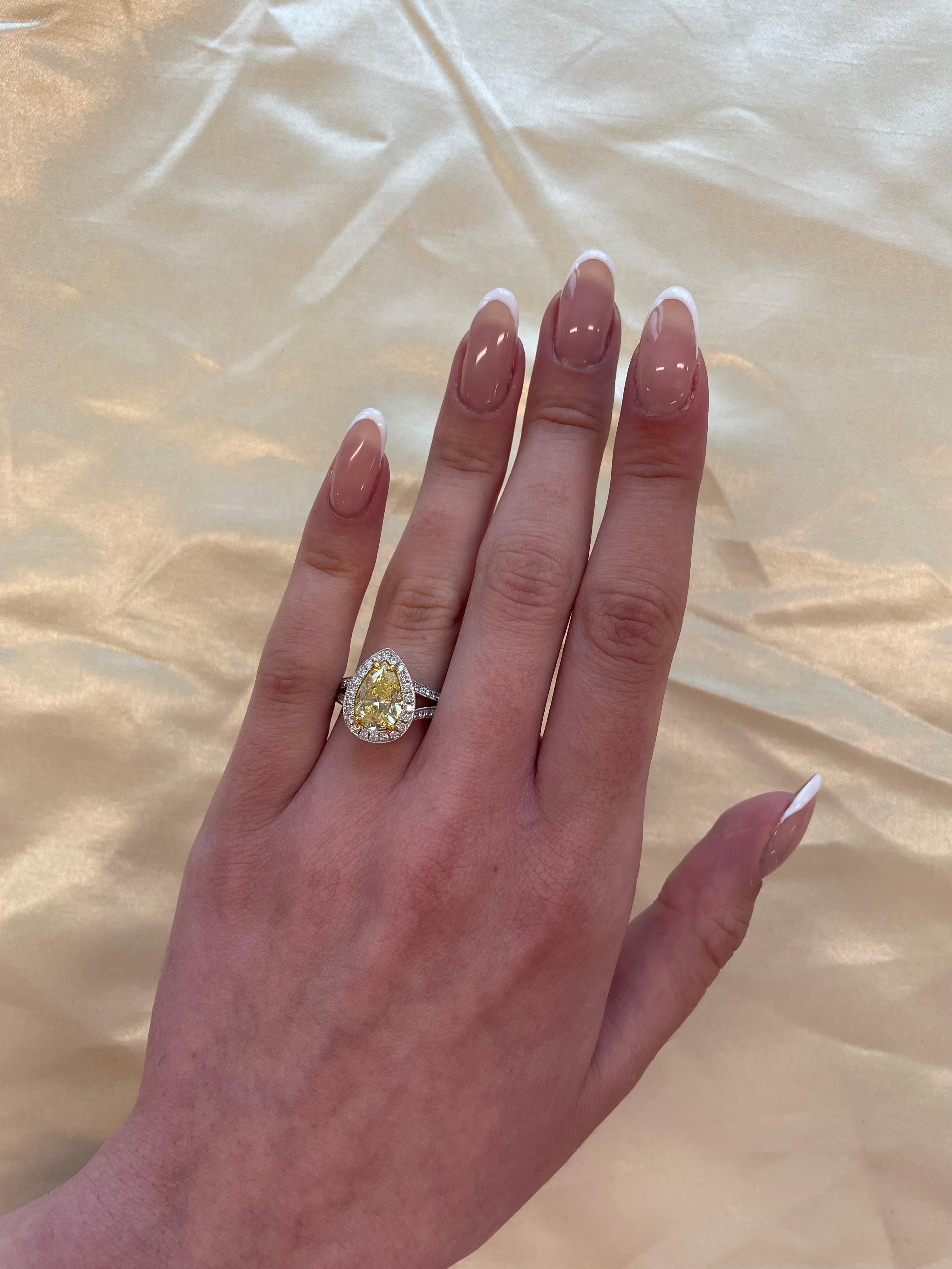 Stunning modern EGL certified yellow diamond with halo ring, two-tone 18k yellow and white gold. By Alexander Beverly Hills
3.07 carats total diamond weight.
2.50 carat pear cut Fancy Vivid Yellow color and I1 clarity diamond, EGL graded.