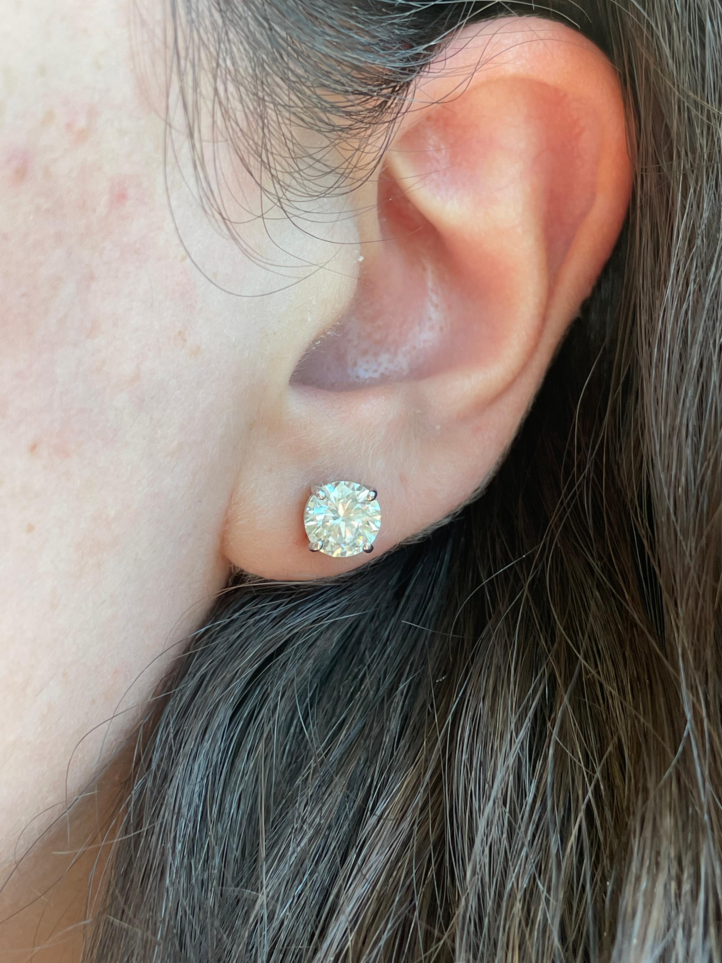 Classic diamond stud earrings, each stone EGL certified, by Alexander Beverly Hills.
Two matching round brilliant diamonds 2.21 carats total. Both stones G color grade, one stone SI1 clarity grade and the other SI2 clarity grade. 14k white
