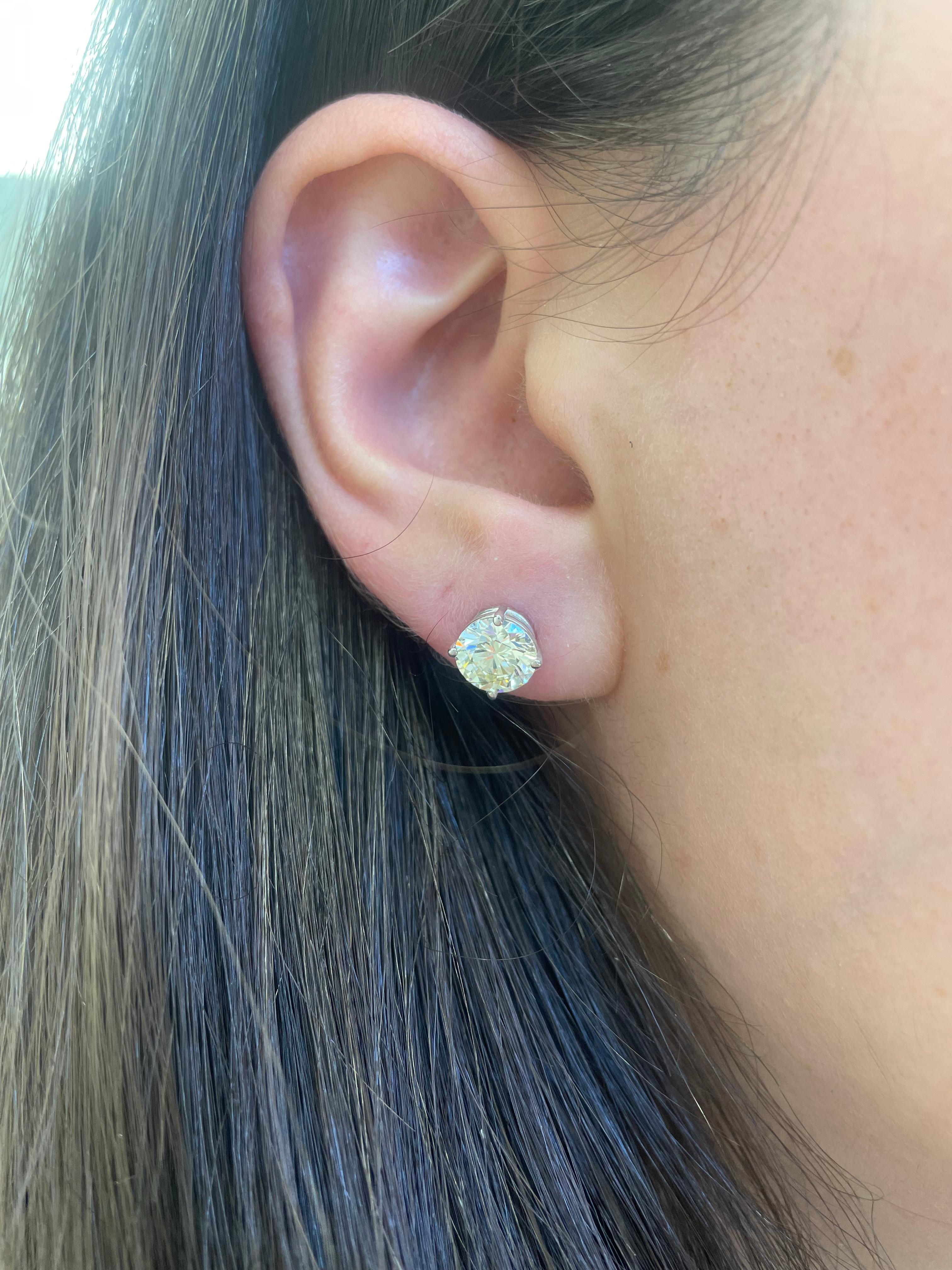 Classic diamond stud earrings, each stone EGL certified, by Alexander Beverly Hills.
Two matching round brilliant diamonds 2.51 carats total. Both stones L color grade, one stone VS1 clarity grade and the other VS2 clarity grade. 18k white