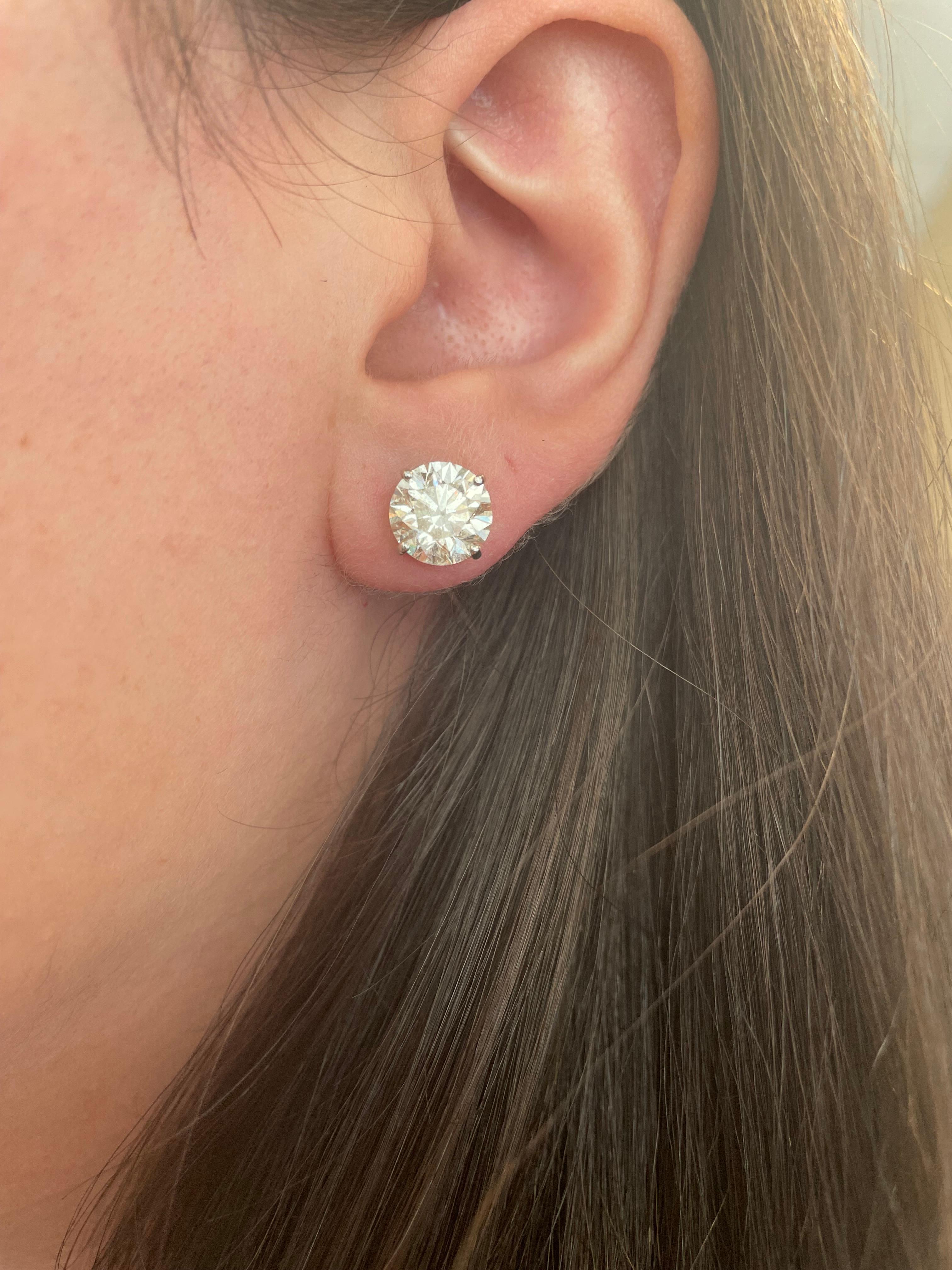 Classic diamond stud earrings, each stone EGL certified. High jewelry by Alexander Beverly Hills.
Two matching round brilliant diamonds 4.91 carats total. One stone H color grade and the other I color grade, both VS2 clarity. 14k white