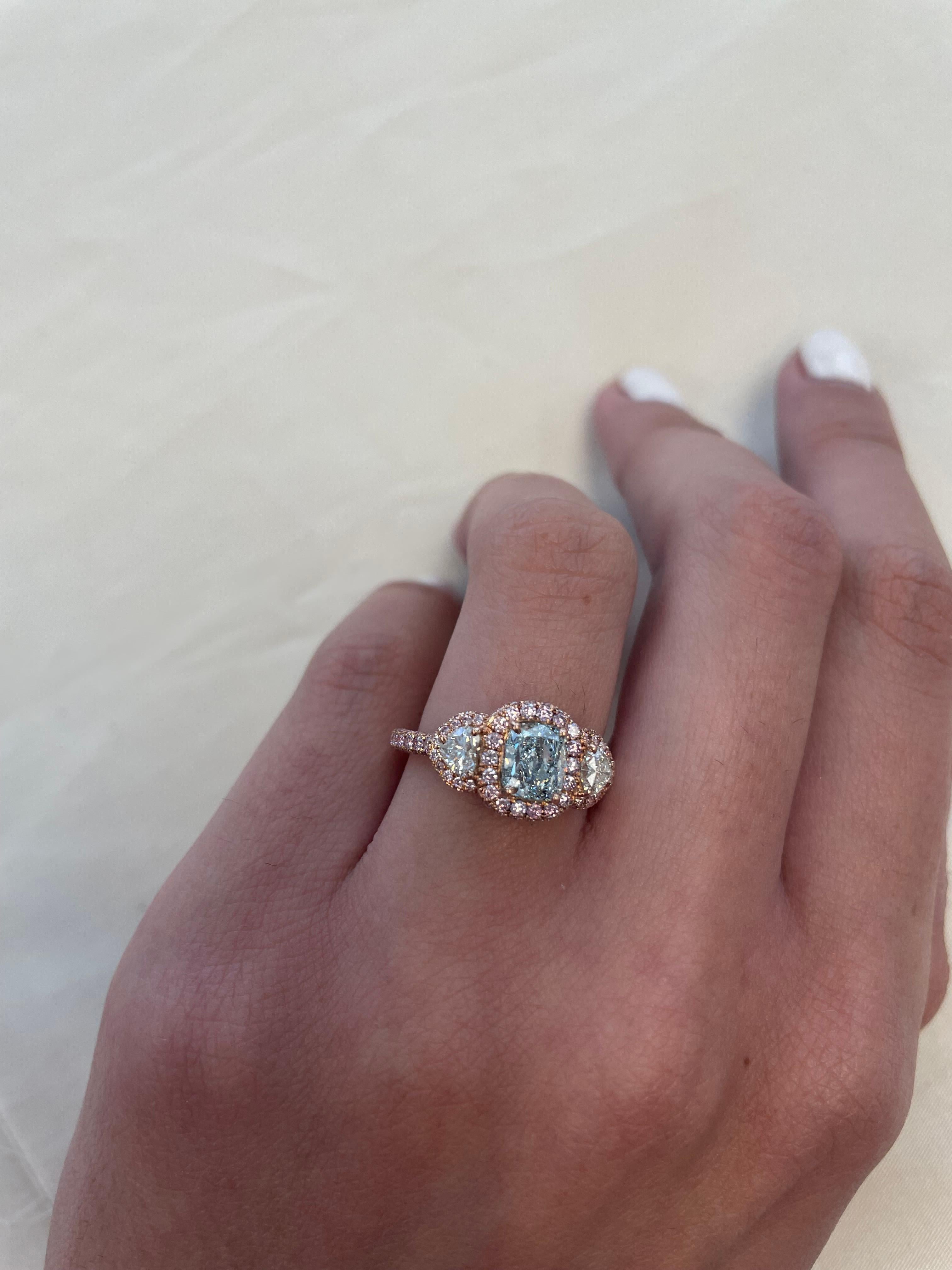 Exquisite and very rare fancy greenish blue diamond with Argyle fancy pink diamonds, GIA certified. 
High jewelry by Alexander Beverly Hills.
Center 1.02 carat cushion diamond, fancy greenish blue color grade and I1 clarity grade. Complimented with