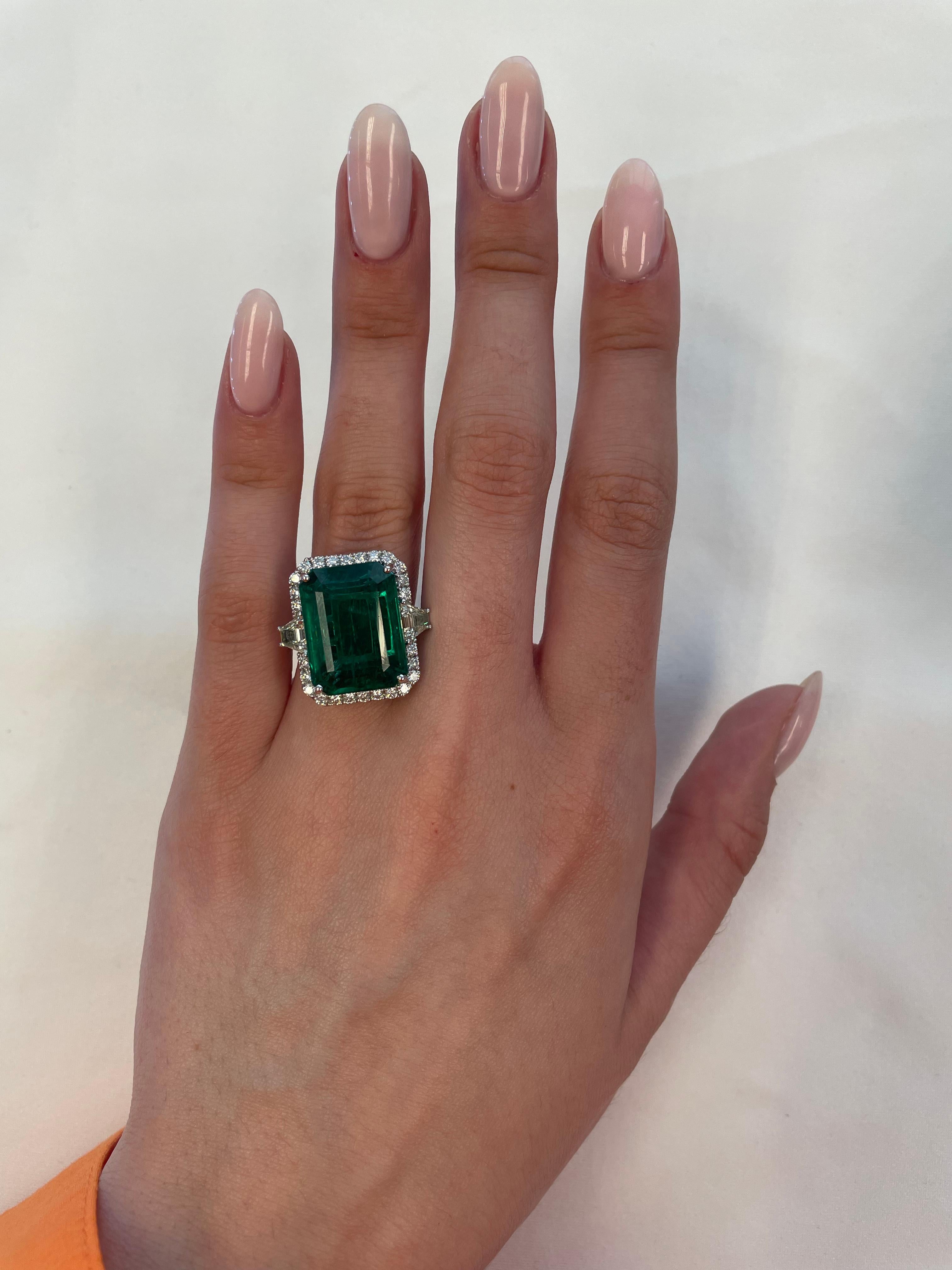Stunning emerald of superb color and diamond three stone ring with halo, GIA certified. High jewelry by Alexander Beverly Hills. 
14.58 carats total gemstone weight.
*Center emerald faces up like a 20ct stone
13.18 carat emerald cut emerald, GIA