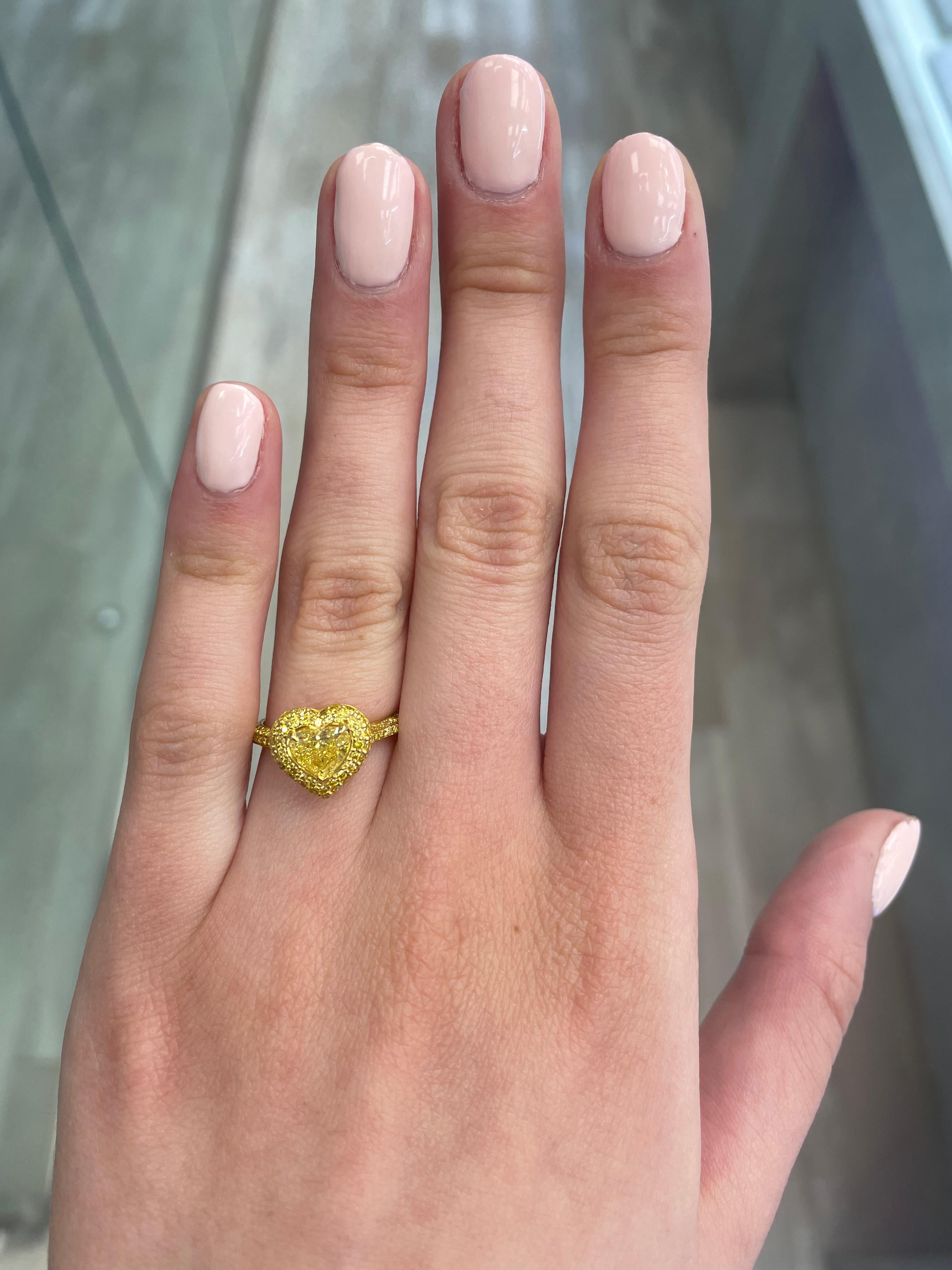 Stunning modern GIA certified yellow diamond with halo ring, two-tone 18k yellow and white gold. High jewelry by Alexander Beverly Hills
1.92 carats total diamond weight.
0.90 carat heart cut Fancy Intense Yellow color and SI2 clarity grade, GIA