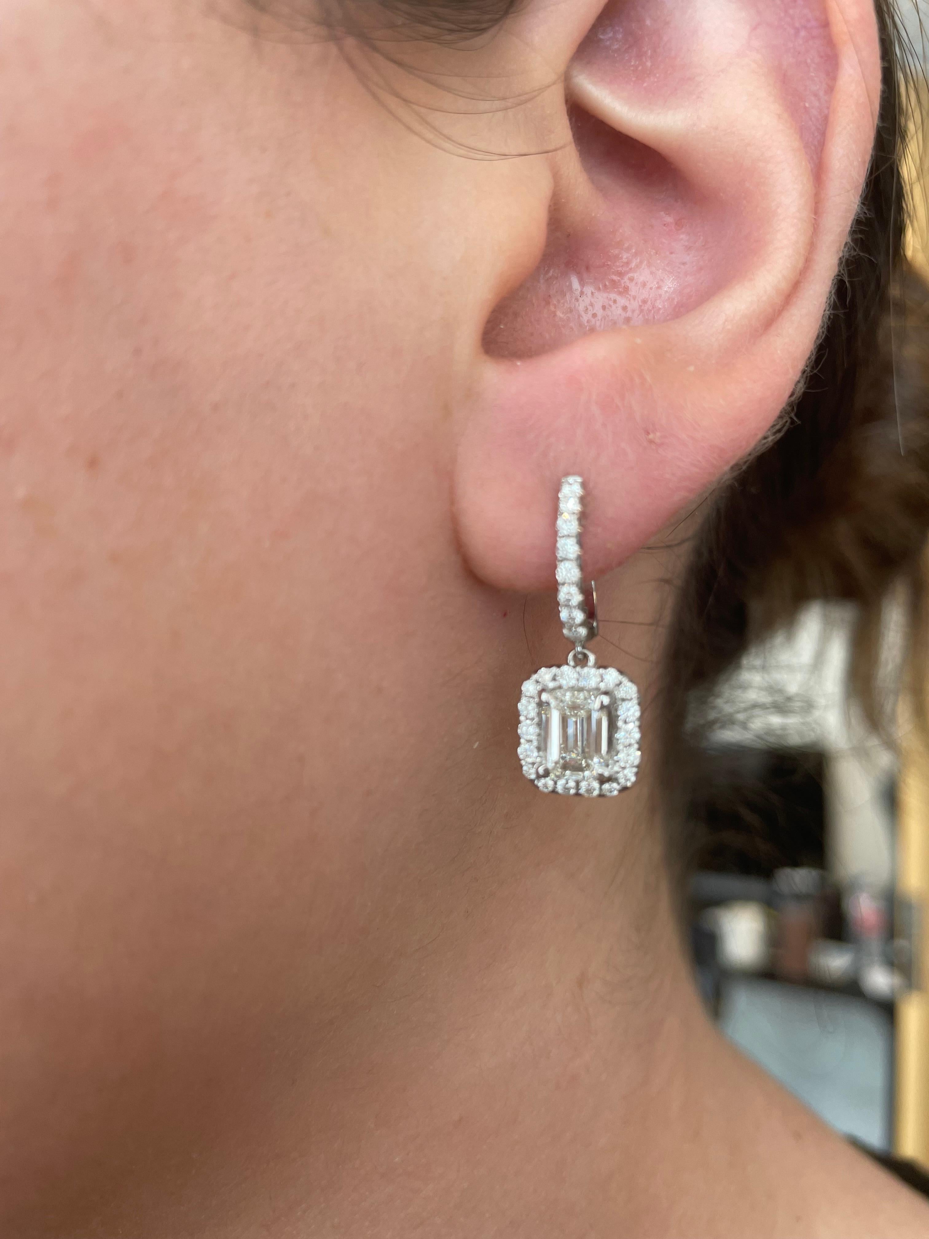 Stunning emerald cut diamonds with halo earrings, GIA certified. High jewelry by Alexander Beverly Hills. 
2.68 carats total diamond weight. 
2 emerald cut diamonds, 2.04 carats. Both H color, one stone VS1 clarity and the other VS2 clarity GIA