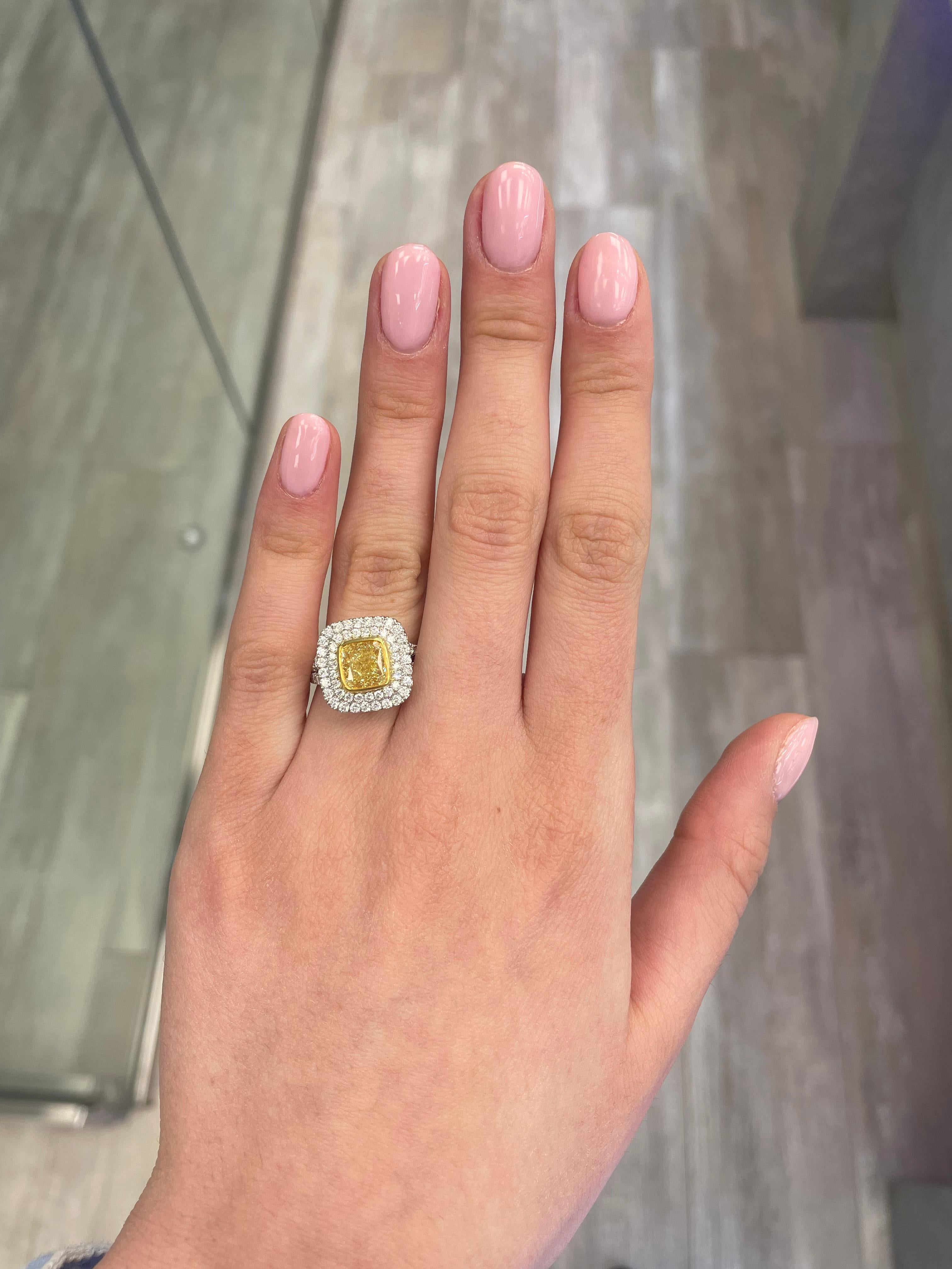 Stunning modern GIA certified yellow diamond double halo ring, two-tone 18k yellow and white gold. By Alexander Beverly Hills
3.44 carats total diamond weight.
2.32 carat cushion cut Fancy Yellow color and VS2 clarity diamond, GIA graded.
