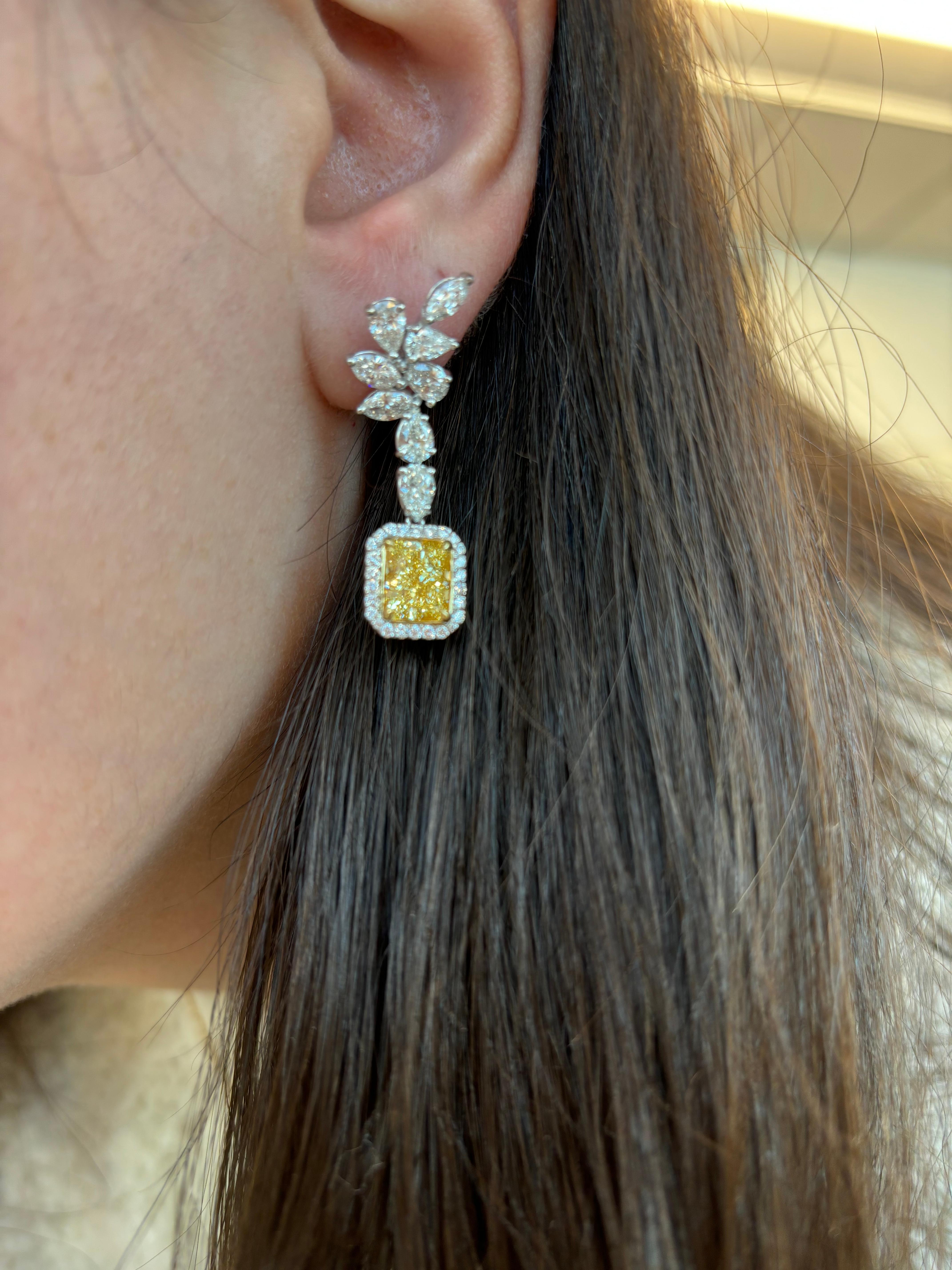 Stunning fancy yellow diamonds (that look fancy intense) with halo earrings, GIA certified. High jewelry by Alexander Beverly Hills. 
*Center stones look Fancy Intense Yellow in the mounting 
7.13 carats total diamond weight.
2 radiant cut diamonds,