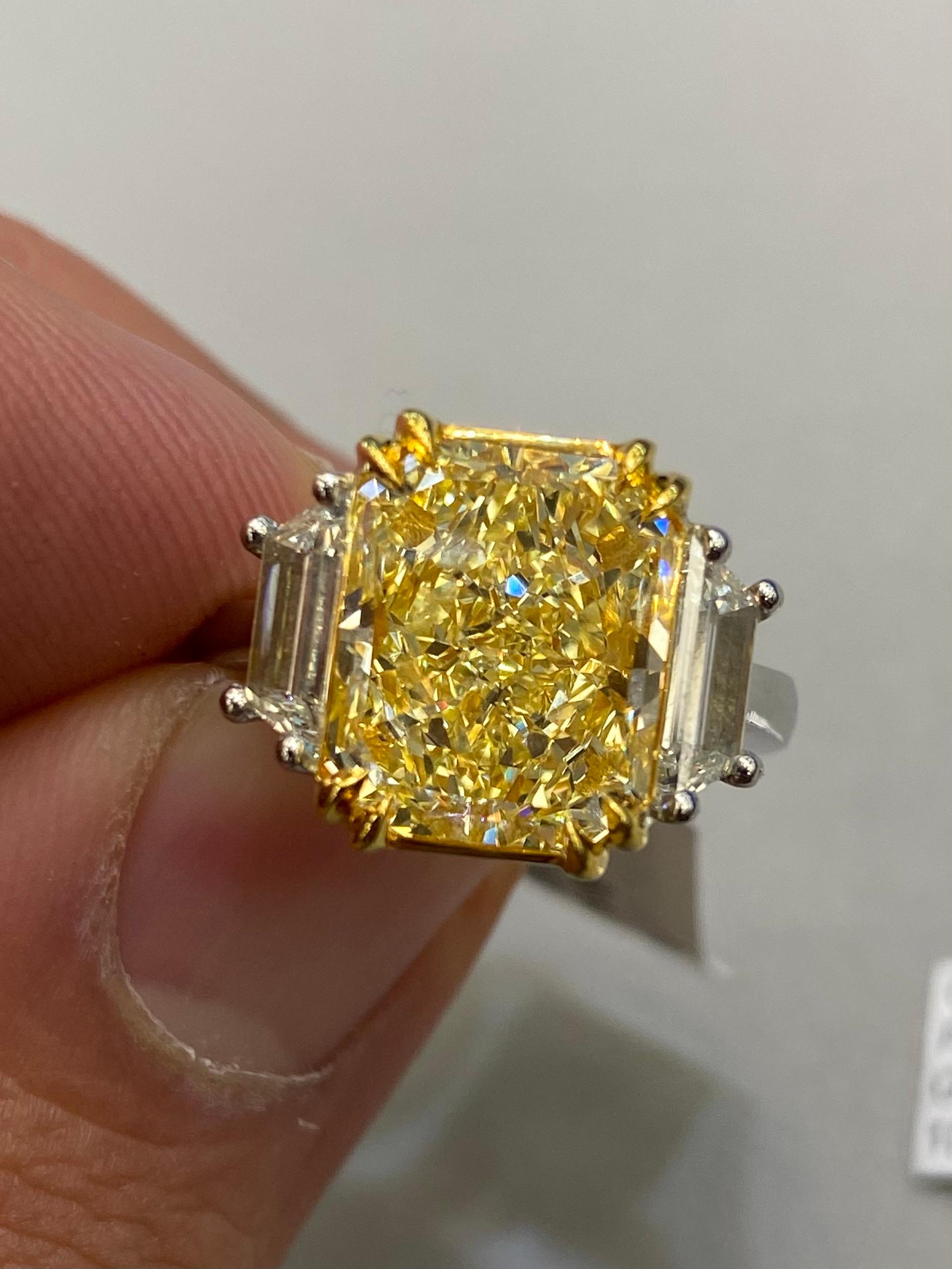 Stunning modern GIA certified fancy yellow internally flawless diamond halo ring, two-tone 18k yellow gold and platinum. 
*Center stone looks like a Fancy Intense Yellow diamond
By Alexander Beverly Hills.
6.38 carats total diamond weight.
5.53