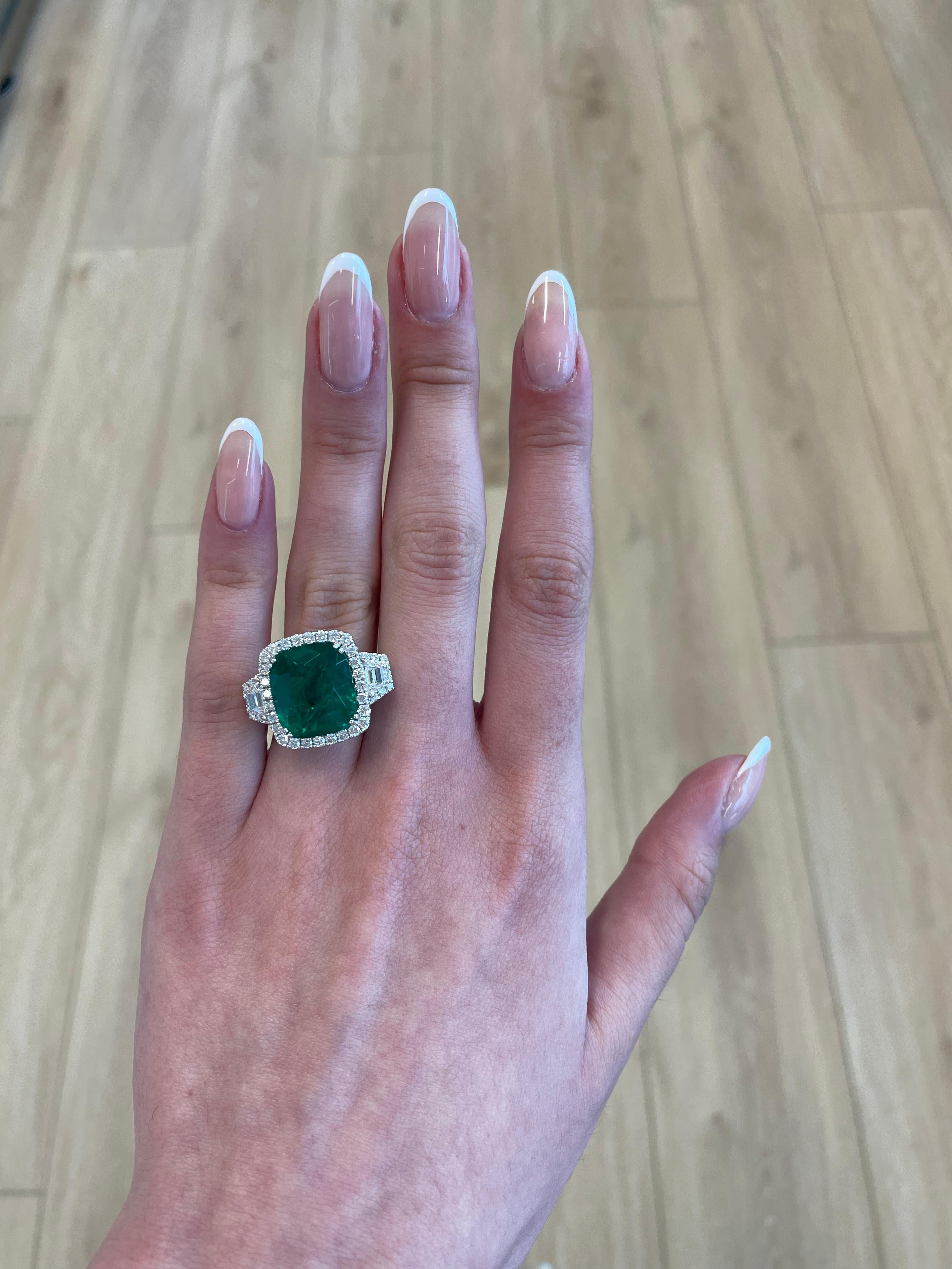 Stunning emerald of superb color and diamond three stone ring with halo. GIA & C. Dunaigre certified emerald and both trapezoid diamonds GIA certified, a total of 4 certificates. High jewelry by Alexander Beverly Hills. 
13.04 carats total gemstone