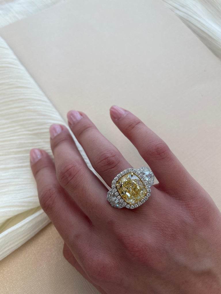 A very impressive 10.25ct fancy yellow Diamond, GIA certified. Nearly looks fancy intense yellow. Complimented with 2 shield cut diamonds, both also GIA certified.
By Alexander of Beverly Hills
10.25ct cushion cut fancy yellow diamond, VS1 clarity