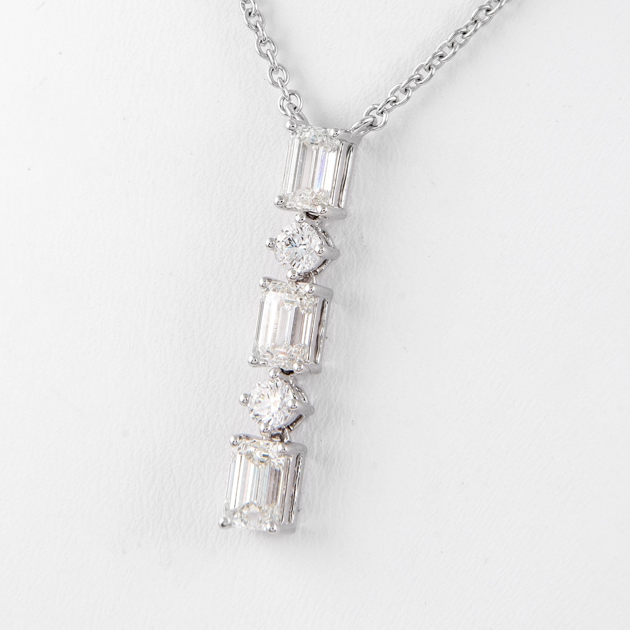 Stunning dangling pendant necklace, GIA certified. By Alexander Beverly Hills.
3 emerald cut diamonds, GIA certified, I-J color, VVS1-VS1 clarity, 1.13ct. Complimented by 2 round brilliant diamonds, 0.30ct. Approximately E/F color and VS clarity.