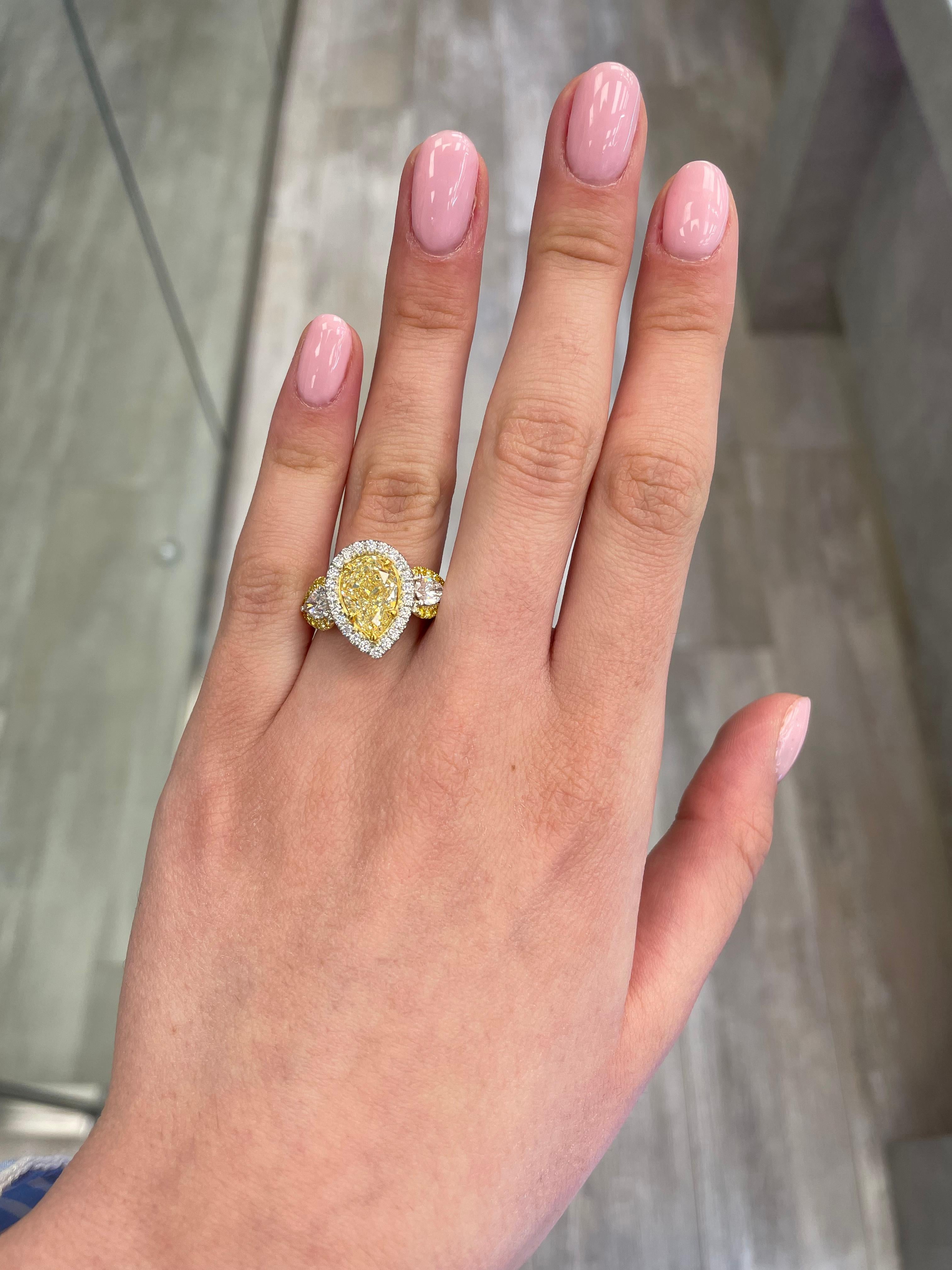 Contemporary Alexander GIA Certified 3.09ct Fancy Yellow Diamond Three-Stone Halo Ring 18k For Sale
