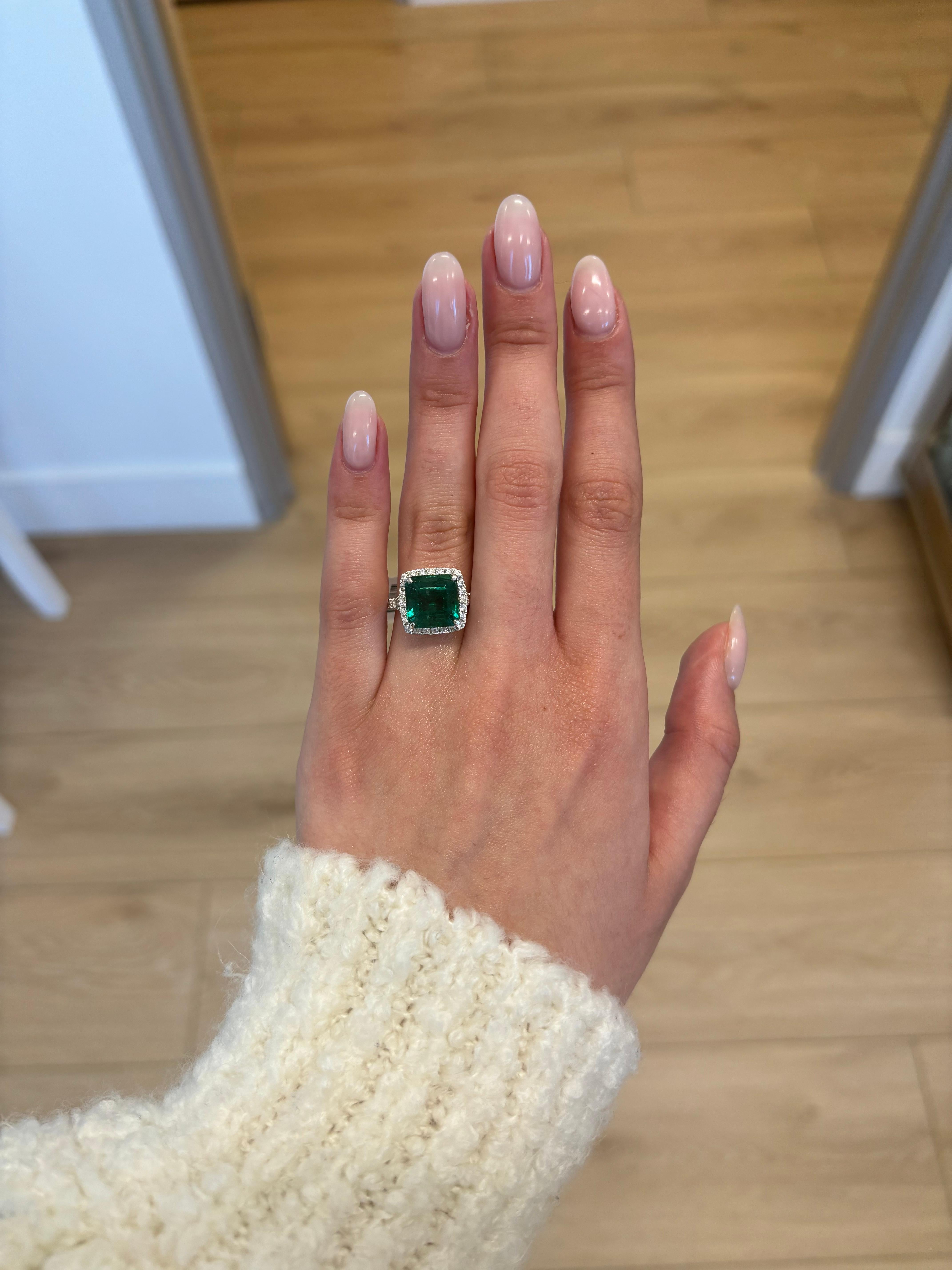 Stunning emerald of superb color with diamond halo ring, GIA certified, by Alexander Beverly Hills. 
5.80 carats total gemstone weight.
5.21 carat emerald cut emerald, approximately F2. 58 round brilliant diamonds, 0.59 carats. Approximately G/H