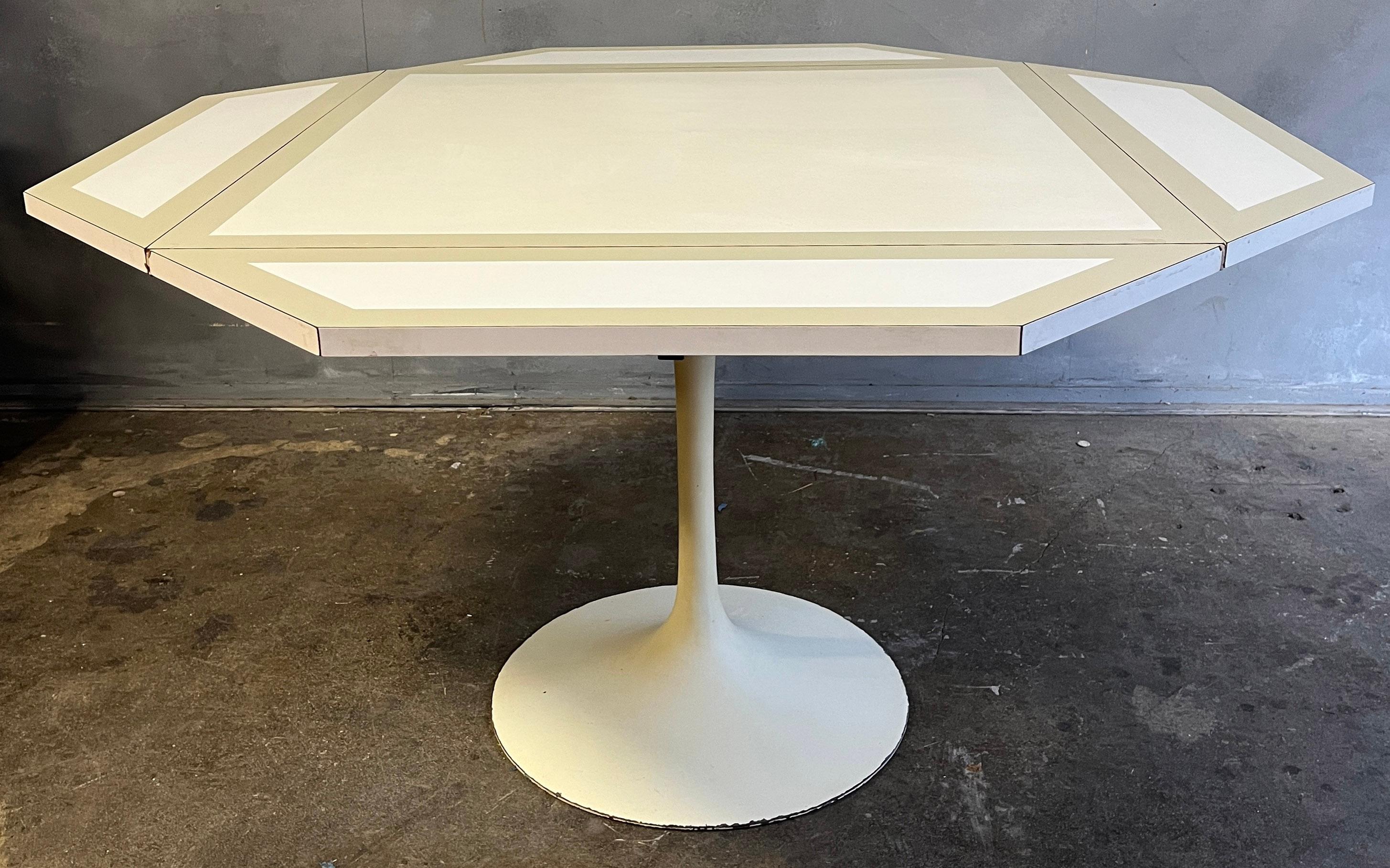 Rare collectors item designed by Alexander Girard. 

Dining table from Dragon Peak House.
This table is one of four examples created for the Dragon Peak House. Features four folding leaves; table measures 34 w x 34 d inches when folded. Laminate and