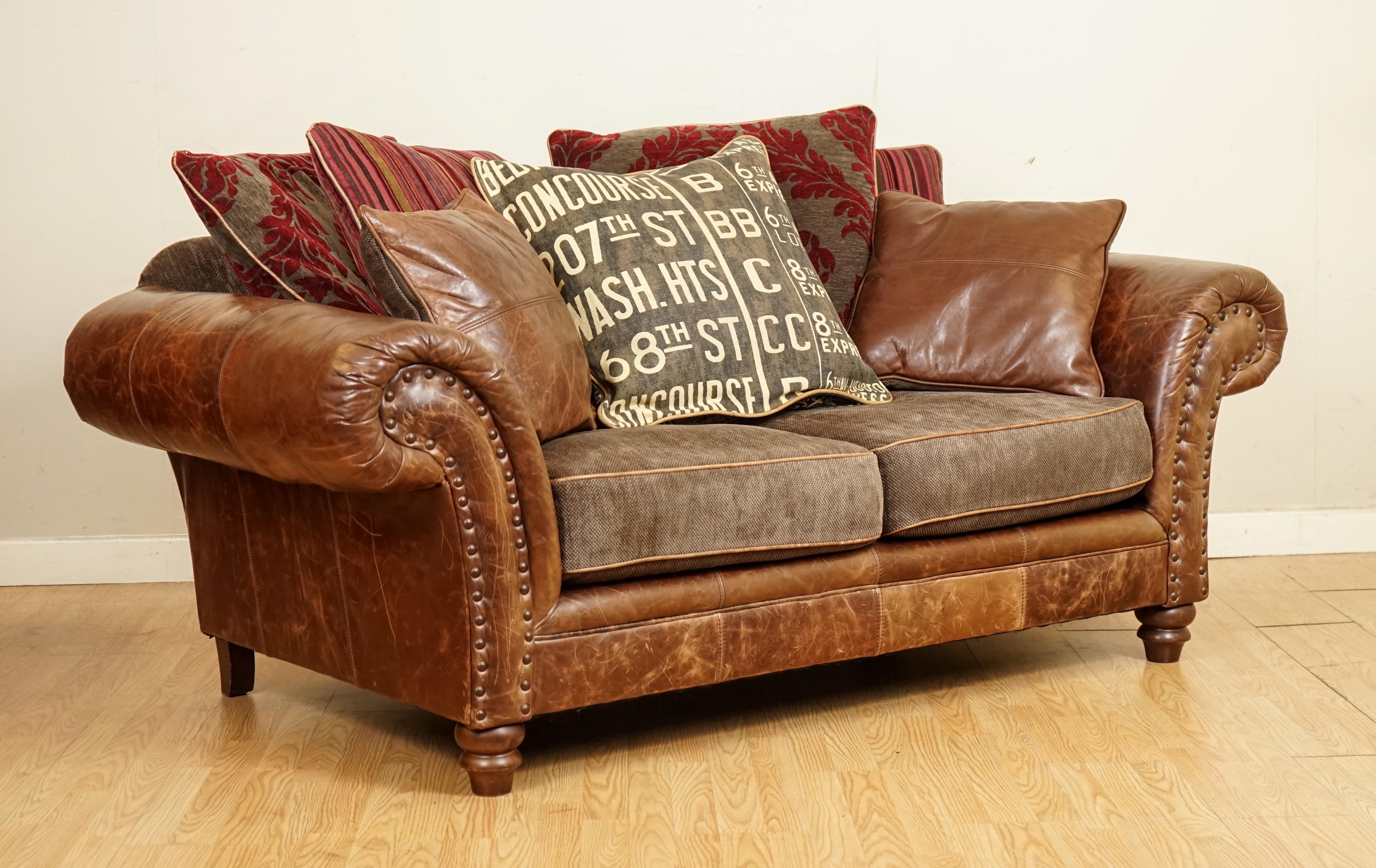 We are so excited to present to you this Alexander & James Chesterfield two seater leather and fabric sofa with Scatter Cushions.

There is a small repair on the leather under the right arm, which isn't noticeable.

A very well made, solid and