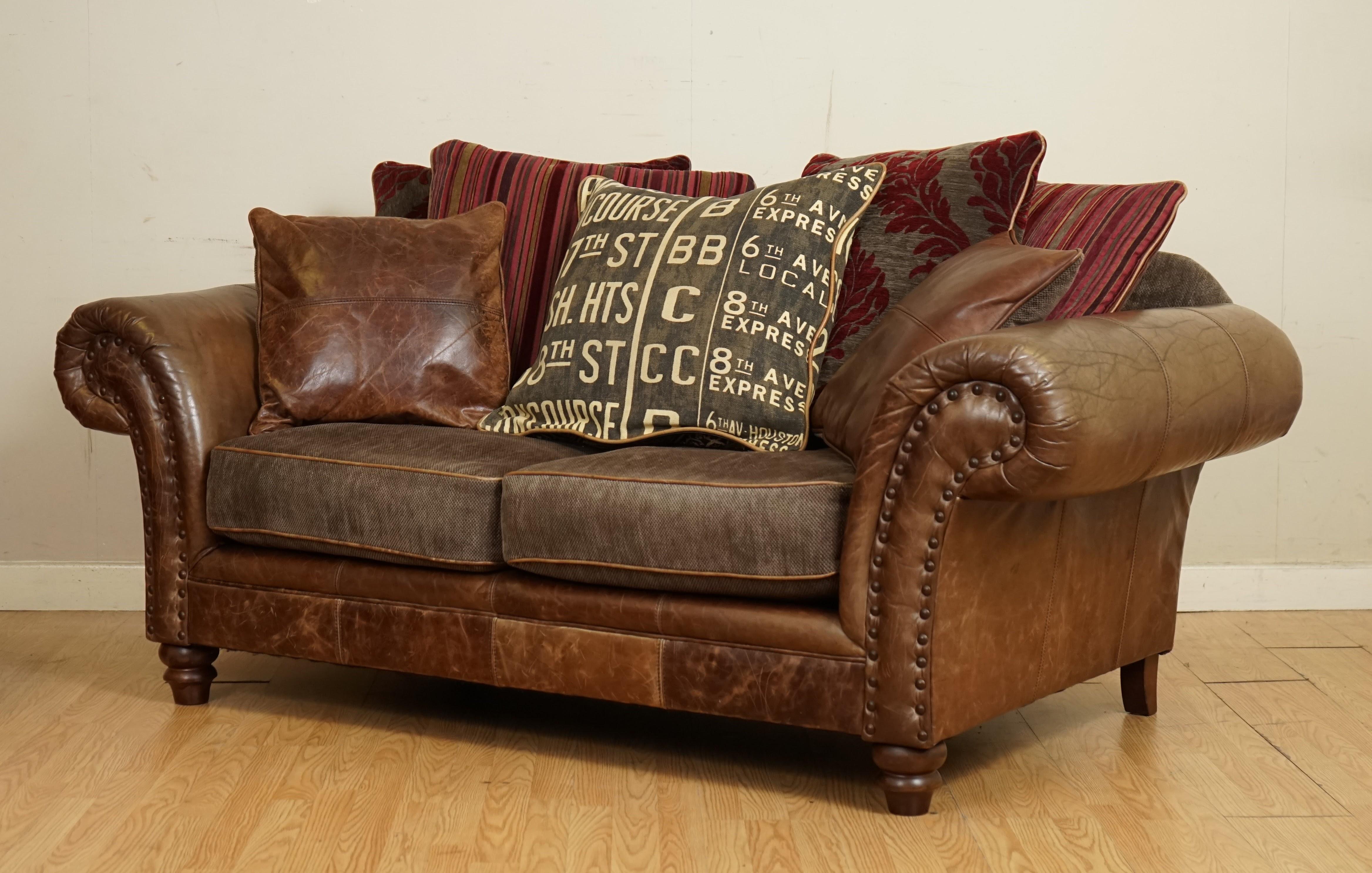 leather sofa with fabric cushions
