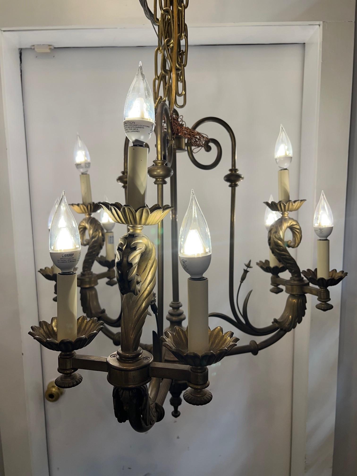 A very nice brass chandelier with three arms and nine lights in a antique brass finish. This is a Alexander-John chandelier a division of John Richard, a luxury home furnishings manufacturer. I believe it was manufactured in Vietnam in the late
