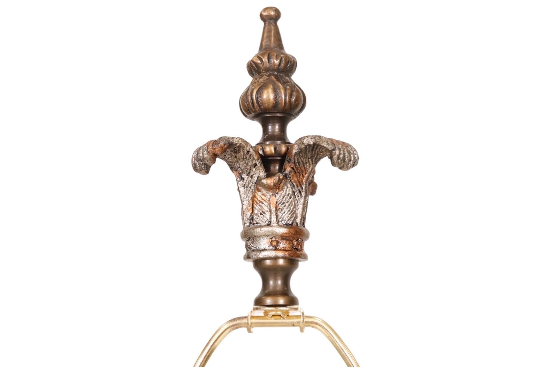 A pair of French Empire table lamps by Alexander John. Finials and tall central columns are decorated with a repeating cast motif of three feathers. The lower of which supports marbled black and white bakelite spheres. Two lucite blocks and cast