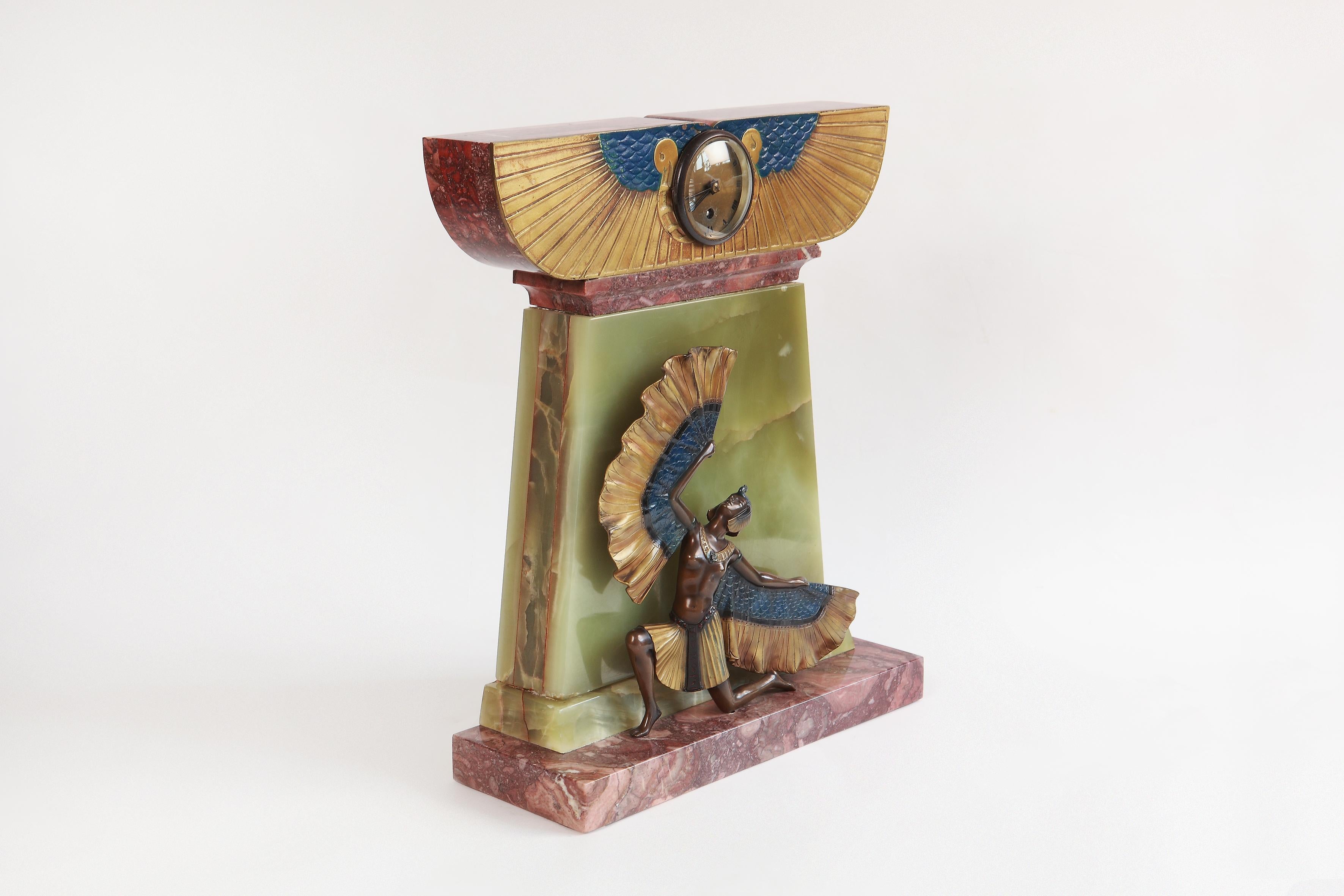 Art Deco mantel clock in Egyptian style, France, circa 1925. Bronze cold-painted, onyx, marble base. Signed top right on the base: KELETY.
Measurements: Height 20.47 in ( 52 cm ), Width 16.54 in ( 42 cm ), Depth 5.91 in ( 15 cm )

Alexander Kéléty,