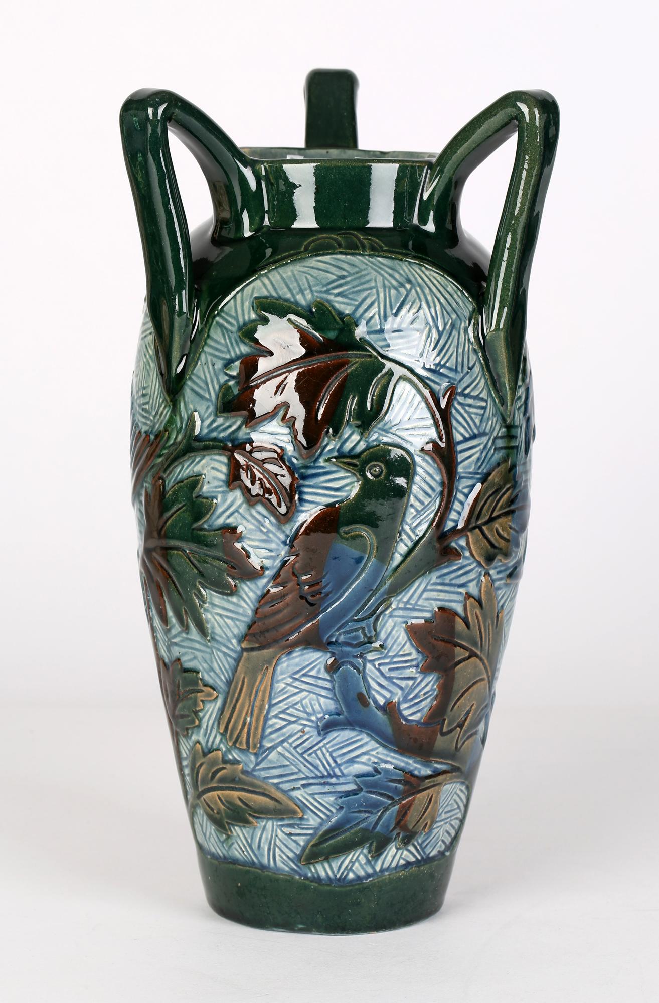 A very stylish Barnstaple, Devon three handled sgraffito art pottery vase decorated with birds by Alexander Lauder (British, 1836-1921) dating from around 1890. The lightly potted earthenware vase is of tall baluster shape standing on narrow flat