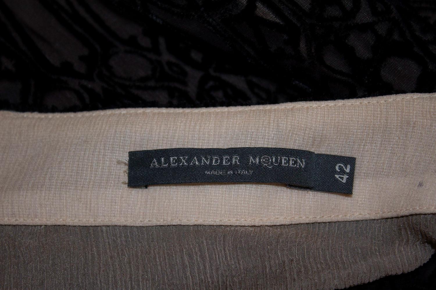A stunning skirt  by Alexander Mc Queen mainline. The outer fabric is black devoree velvet, and the skirt is lined in  silk. It is a great design with a flared hem.  Made in Italy. Size 42
Measurements: Waist 31'', Length 32''.