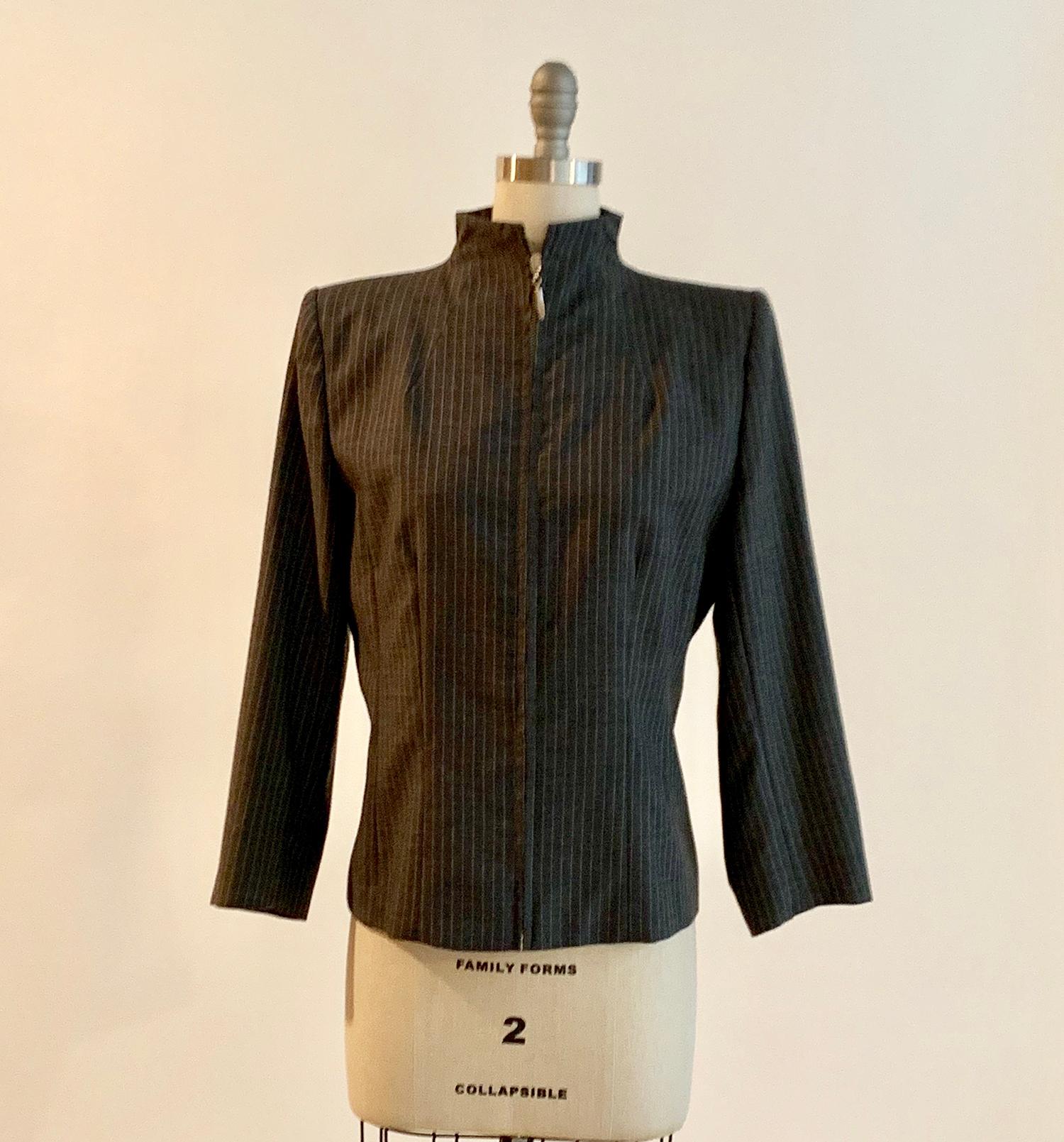 Alexander McQueen vintage 1990s grey pinstripe jacket with zip front. Iconic McQueen tailoring with mid-weight padding at shoulders and four logo buttons at each cuff. Branded 'McQueen' at zipper. (Lining and buttons indicate this piece is most