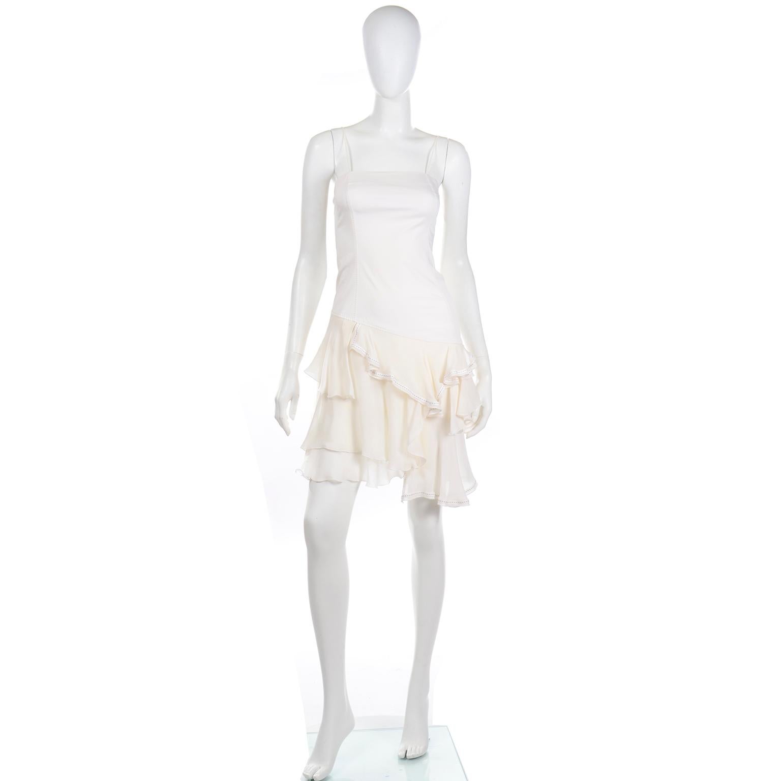 We love vintage Alexander McQueen and he designed this dress for his Spring Summer 1996 collection. This beautiful white dress has a tube fitting bodice with spaghetti straps and fits like a mini dress with attached asymmetrical layered sheer silk