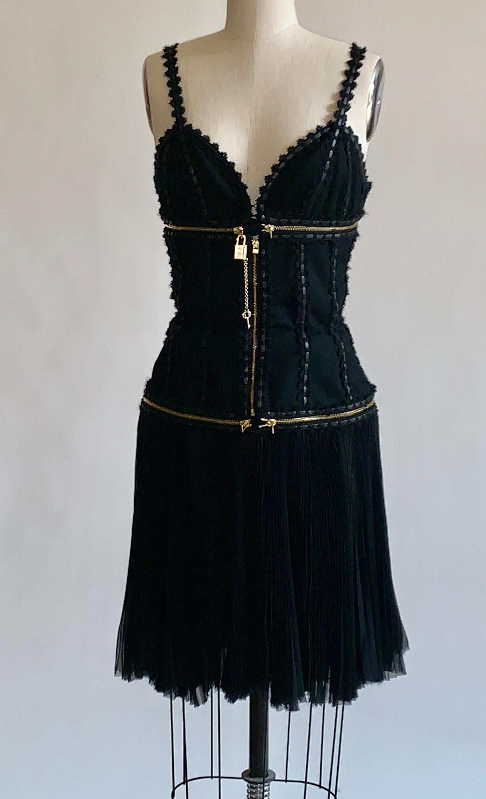 Alexander McQueen 2003 black wool and silk convertible dress (you can zip skirt off to make a corset style top, or zip again to create a bralette top) with a key and lock accent, zipper detailing and a crochet-like and leather trim throughout.