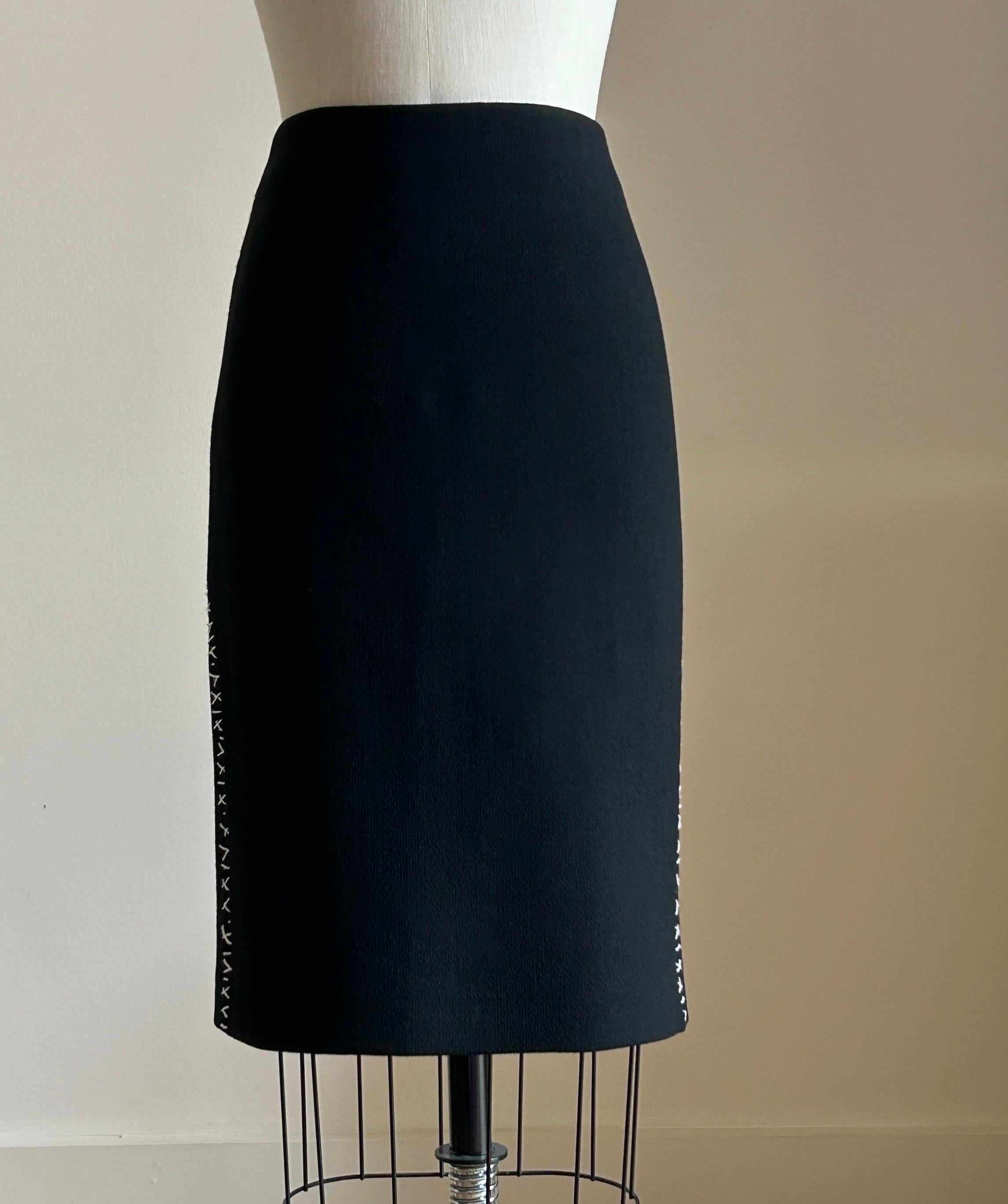 Alexander McQueen 2004 black pencil skirt with white accent stitches at back and sides. Zip and hook and eye at back waist, slit at back center. (Main photo is side view.)

100% wool.
Fully lined.

Made in Italy.

Size Italian 40, approximate US 4.