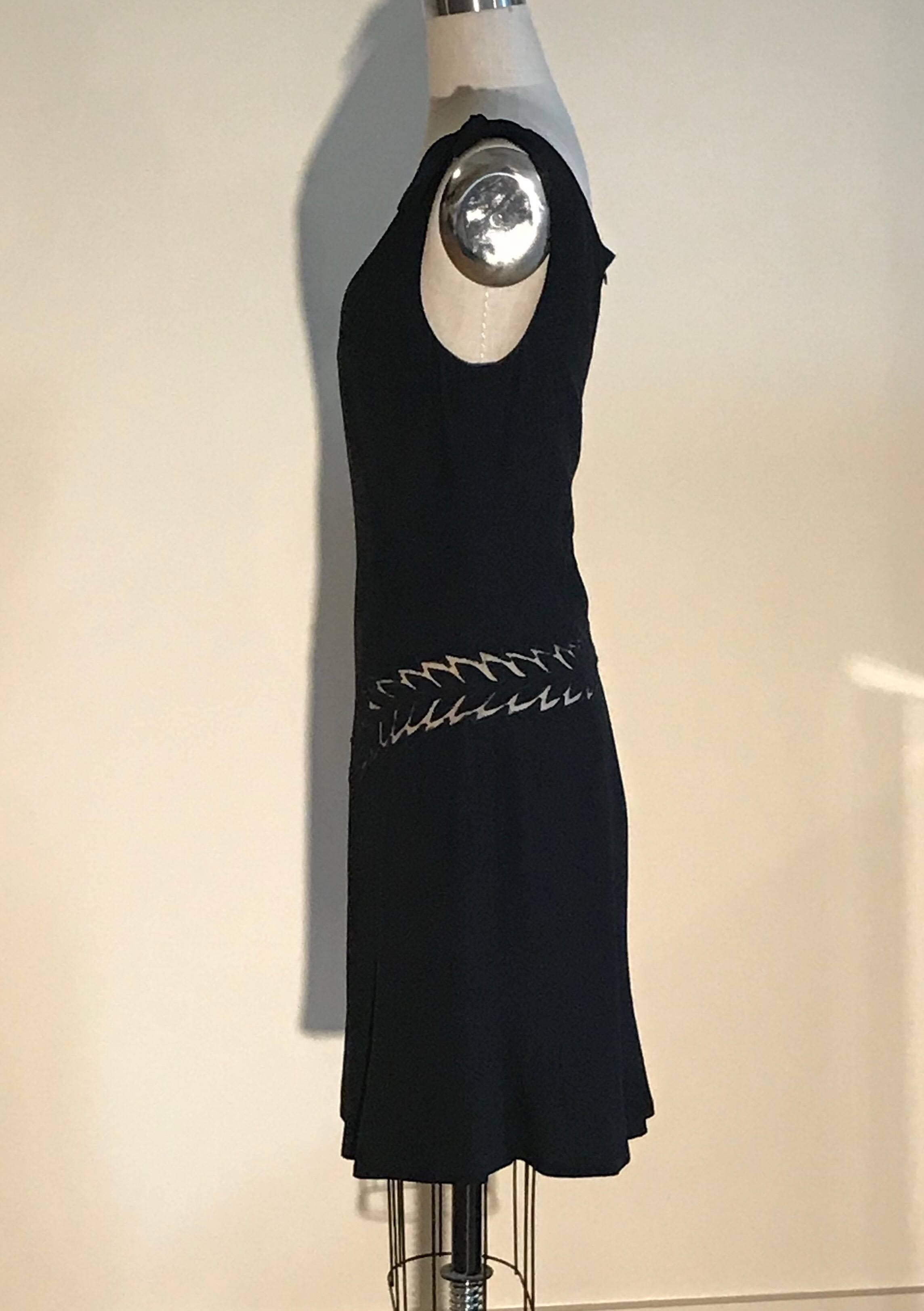 Black Alexander McQueen dress featuring cut out insets that look like feathers or ferns. Decorative ties at shoulders. Back zip.

50% acetate, 50% rayon. 
Fully lined in acetate/nylon.

Made in Italy.

Size IT 44, approximately US 8. See