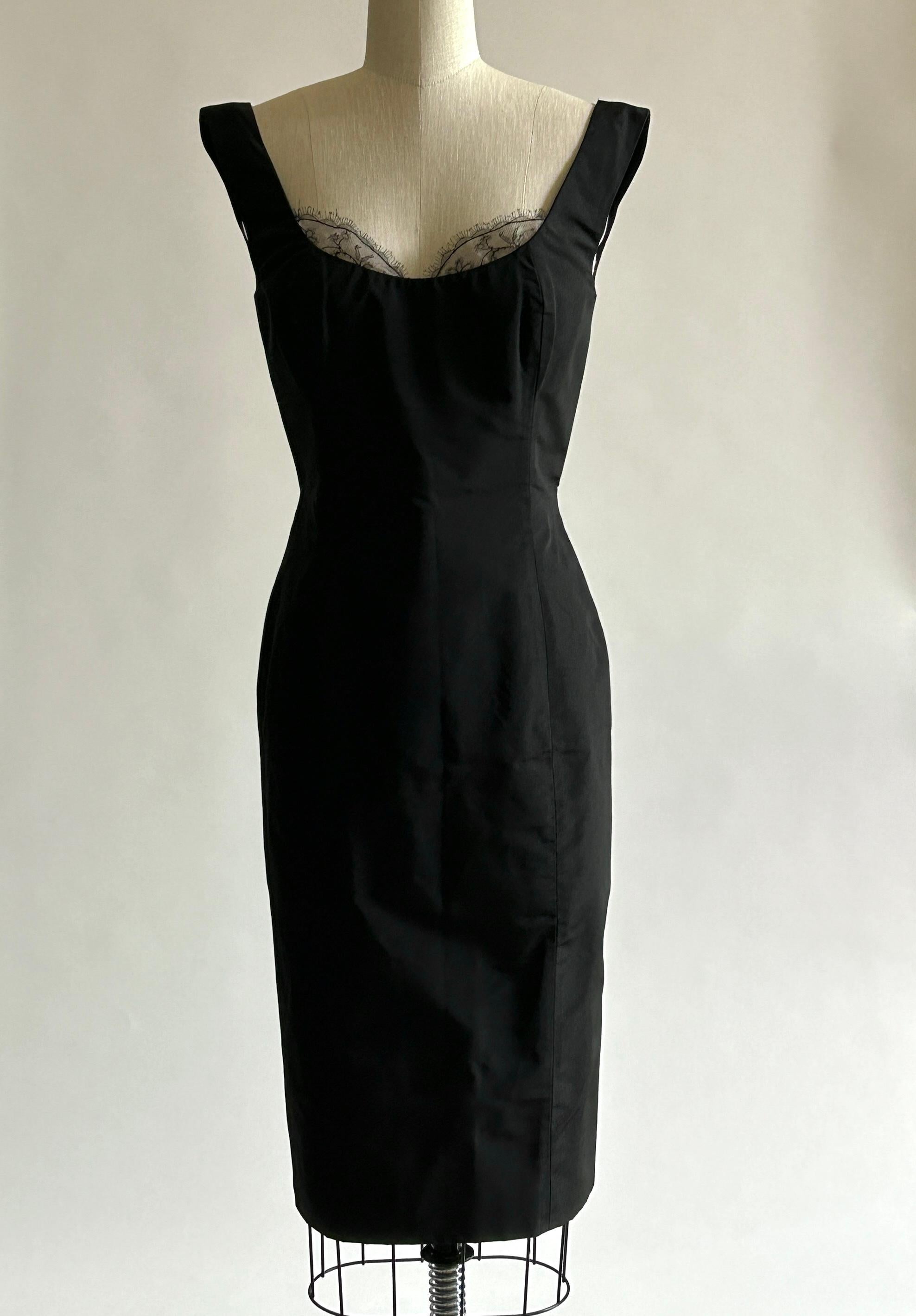 Alexander McQueen black silk dress from the 2005 Hitchcock inspired collection 'The Man Who Knew Too Much,' which channeled Tippi Hedren and Marilyn Monroe. Fitted midi length silhouette with lace accent at bust. Boned at upper bodice. Back zip and