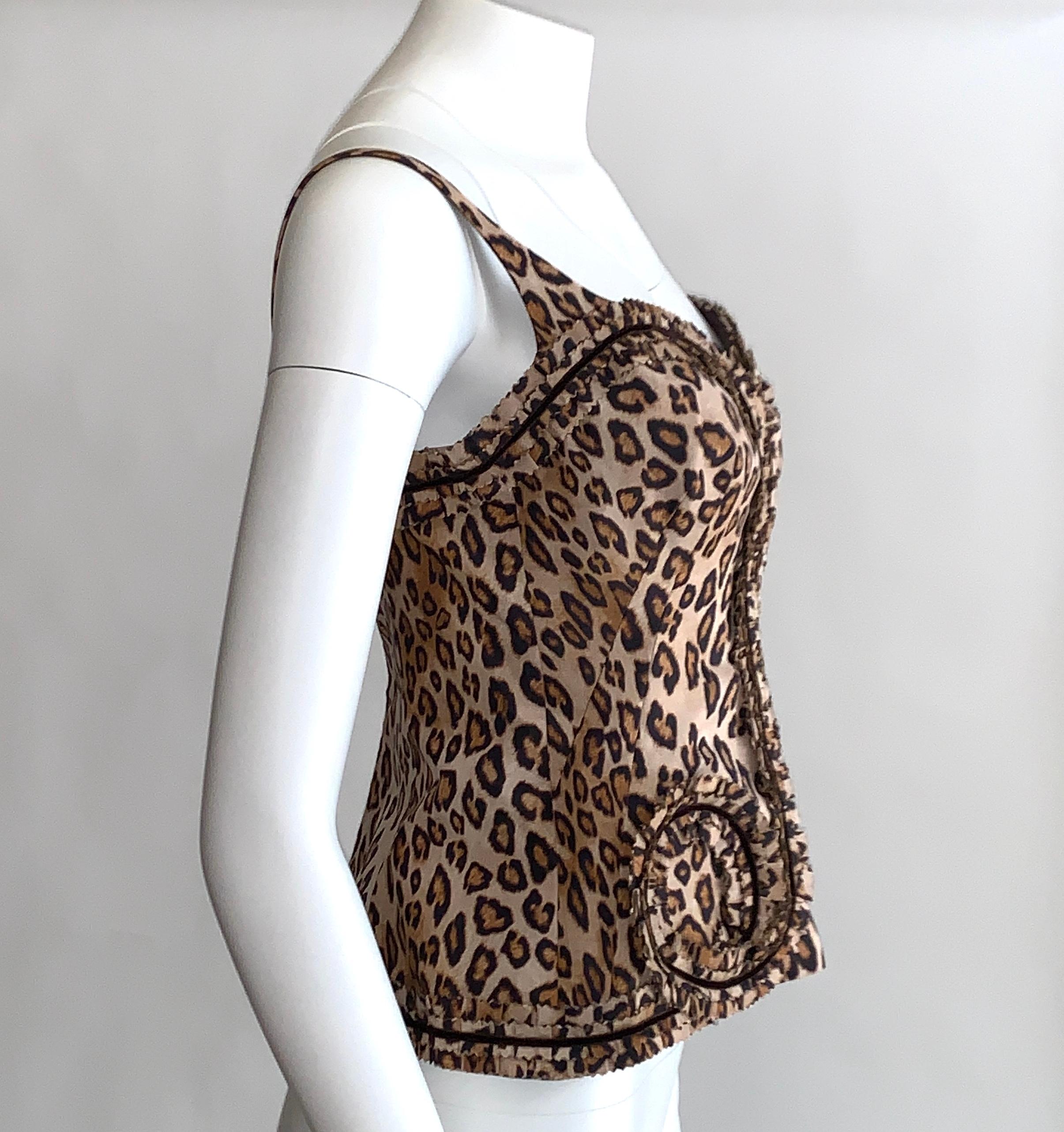 Alexander McQueen leopard print corset style top featuring leopard trim swirl detail with pinked or zig zag edges and velvet accents. Built in bra top with underwire. Back zip and hook and eye. 

From the Fall 2005 Hitchcock inspired collection 'The