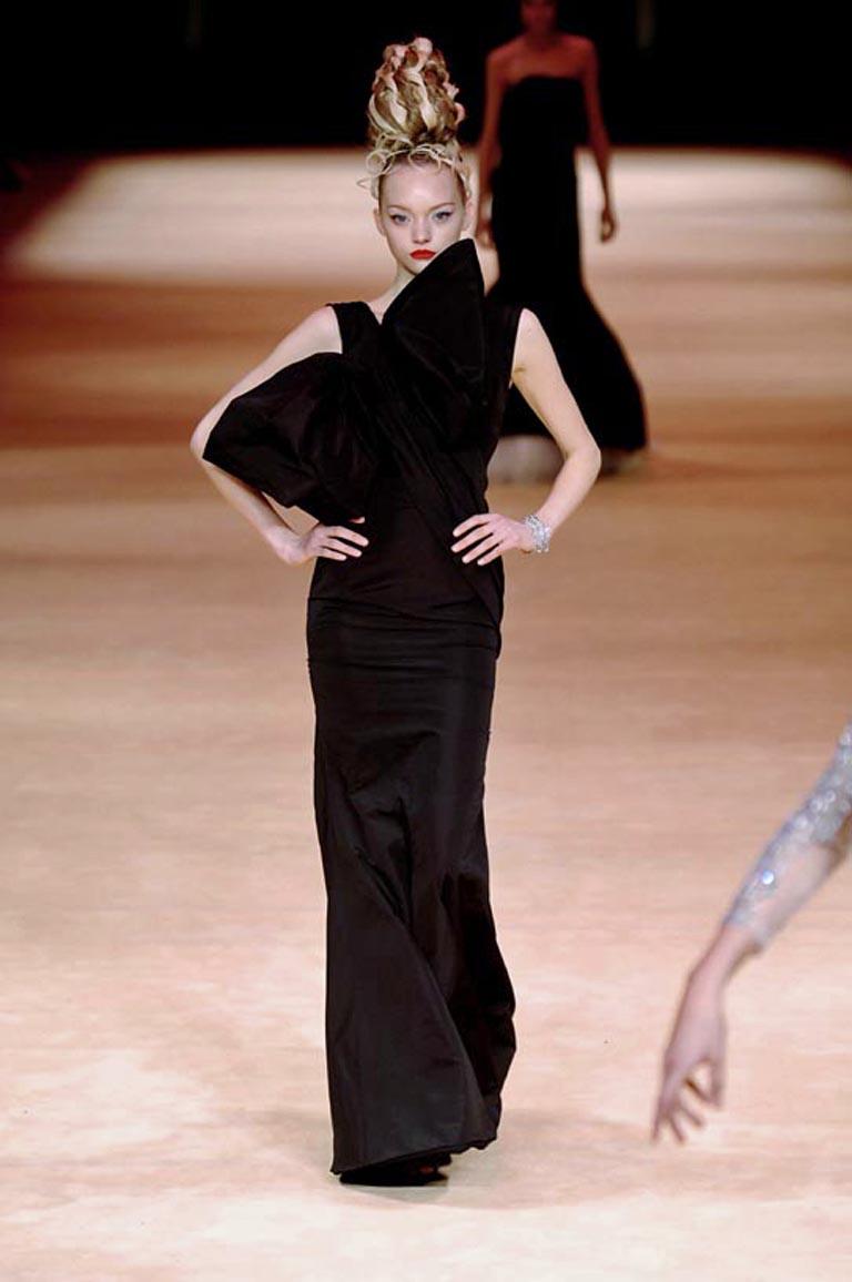 A wonderful high fashion creation pre death Alexander McQueen 2005.   As seen on the runway.  This one shoulder silhouette adorned with large bow adds to the style, structure and bias drape expertly fashioned and inspired by early French Couture. A