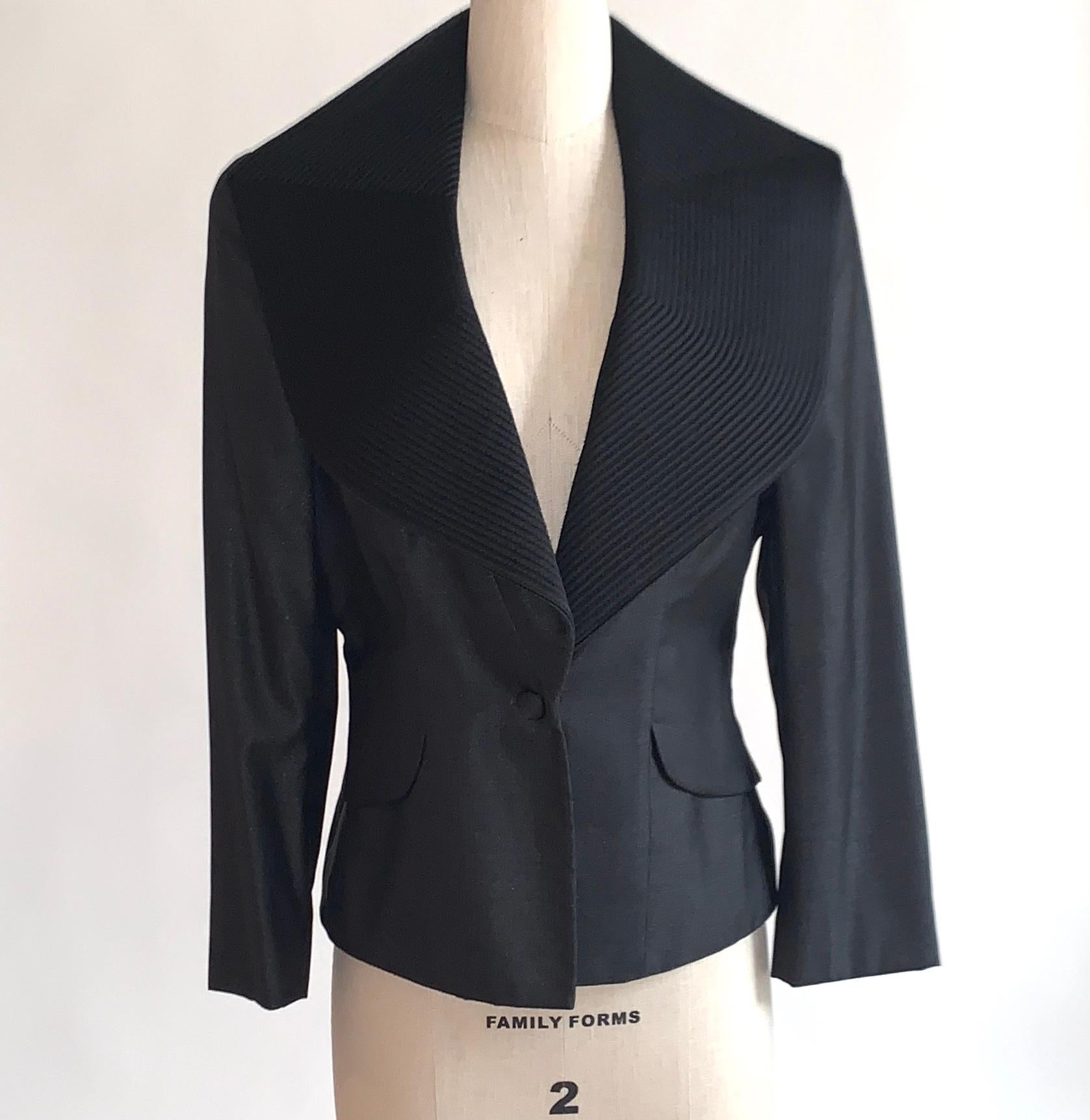 Alexander McQueen tailored blazer in a very dark charcoal grey miniature herringbone featuring amazing black statement collar with stitched detail throughout. Circa 2007. Single cloth covered button closure at front and three at each cuff. Padding