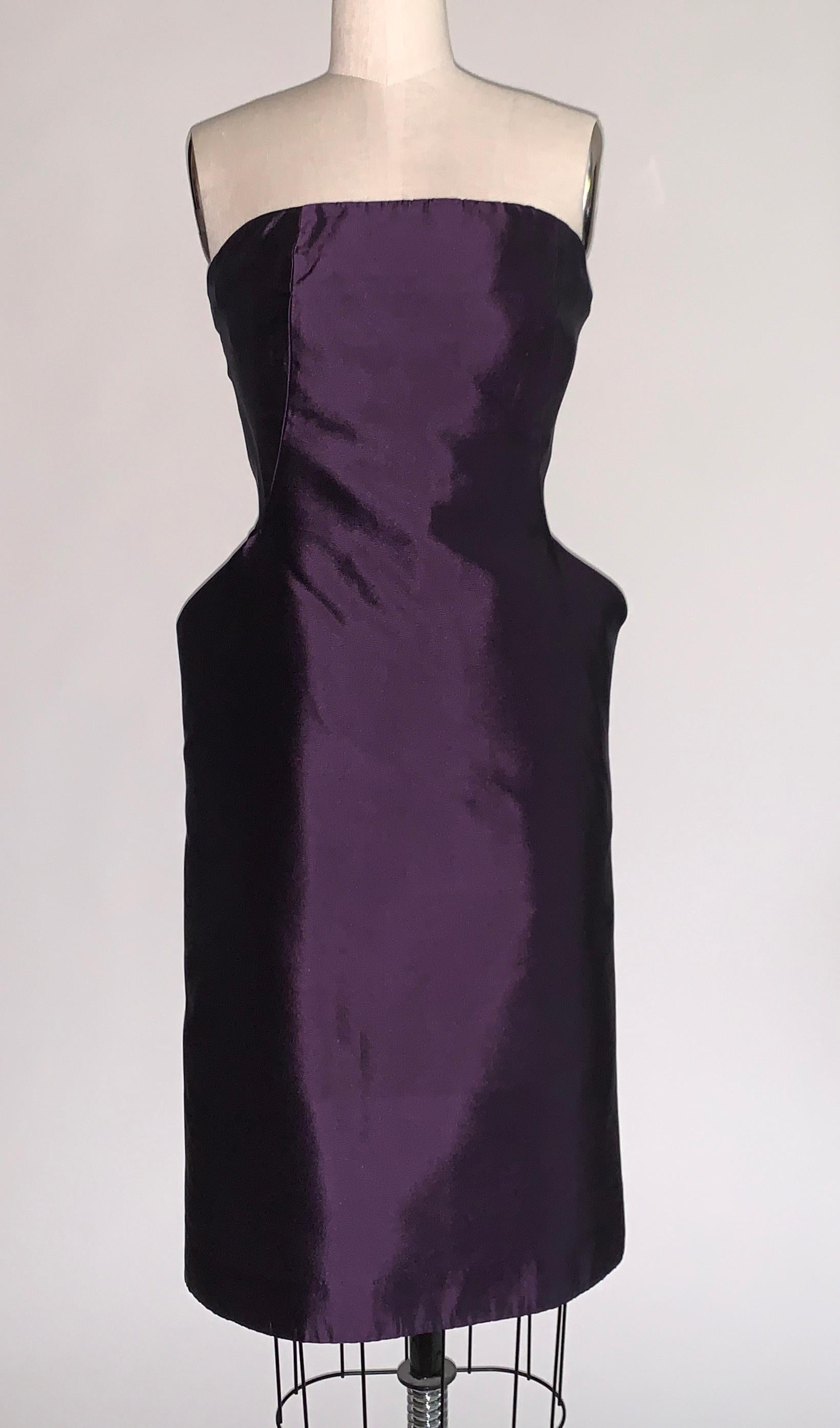 Alexander McQueen purple silk strapless dress with amazing sculptural pockets that flare at hip, giving a dramatic silhouette. Built in bustier/corseting create an even more stunning shape. Back zip and hook and eye. From the Fall 2007 collection,