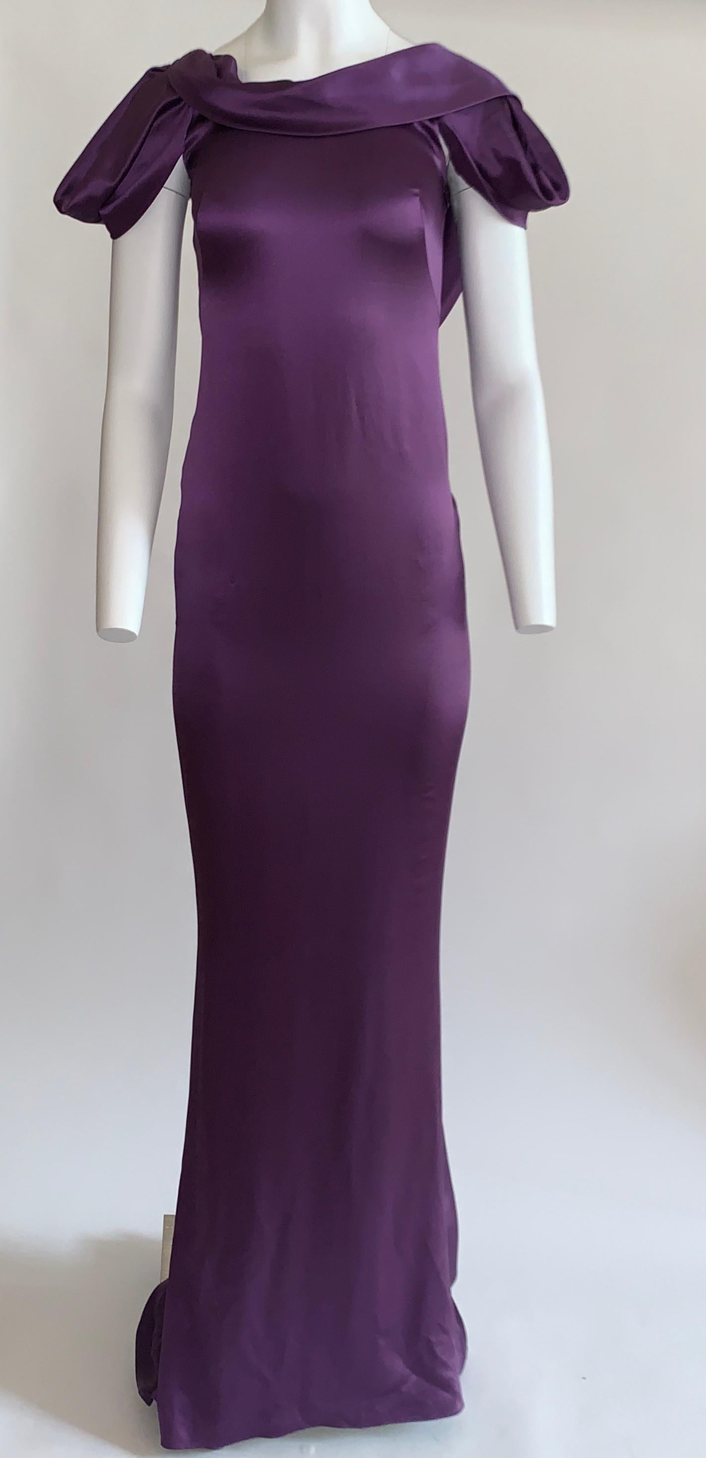 Alexander McQueen 2008 violet purple silk gown with a short sculptural draped sleeve and a deep scoop back. Draping at back extends downward into a short train. Draped collar, back strap extends from shoulder to shoulder and fastens with a snap. 