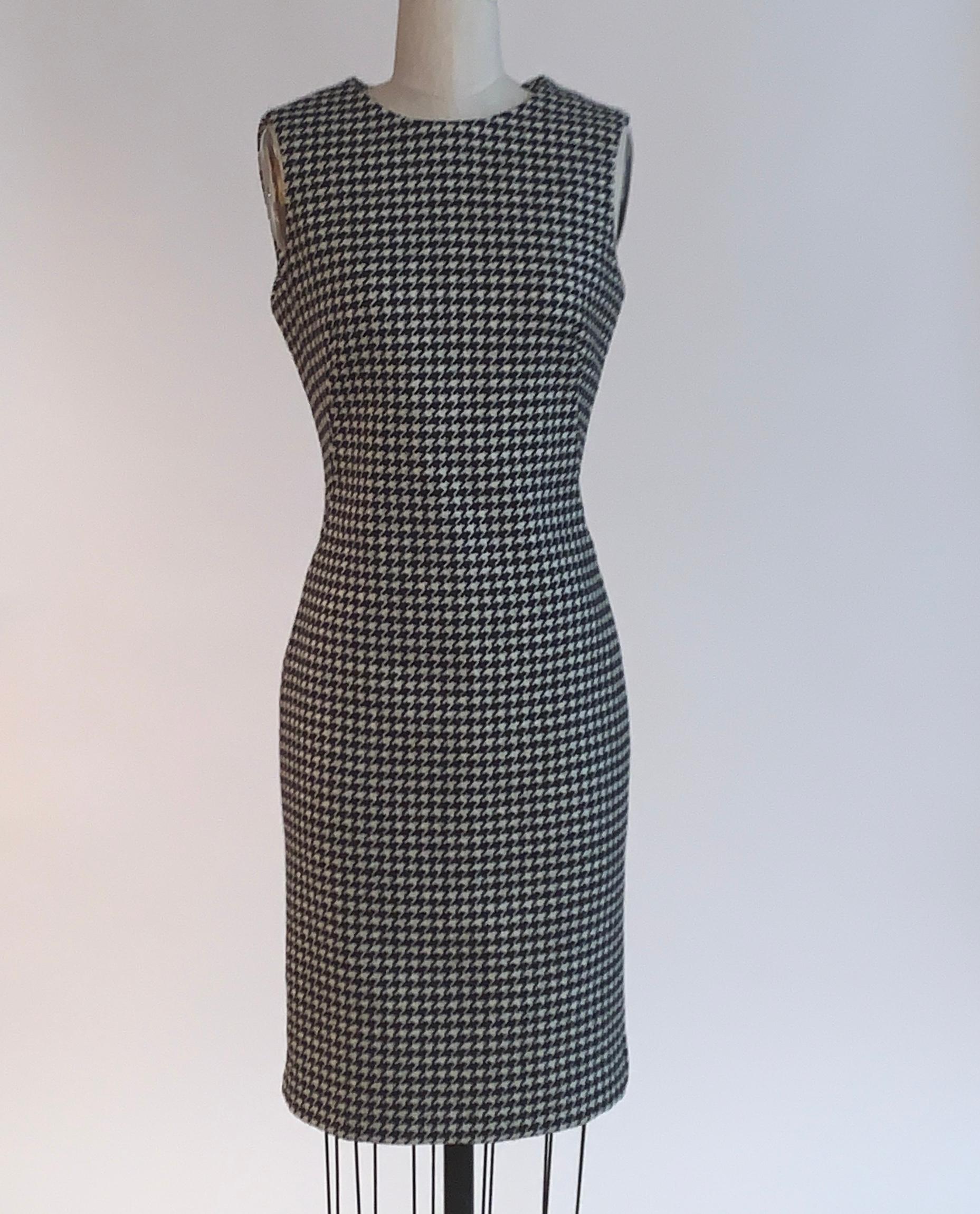 Alexander McQueen sleeveless dress in the black and white houndstooth wool that became so iconic from the Fall 2009 Horn of Plenty collection. Dress is wonderfully tailored and has boning at sides to create a great shape. Back zip and hook and