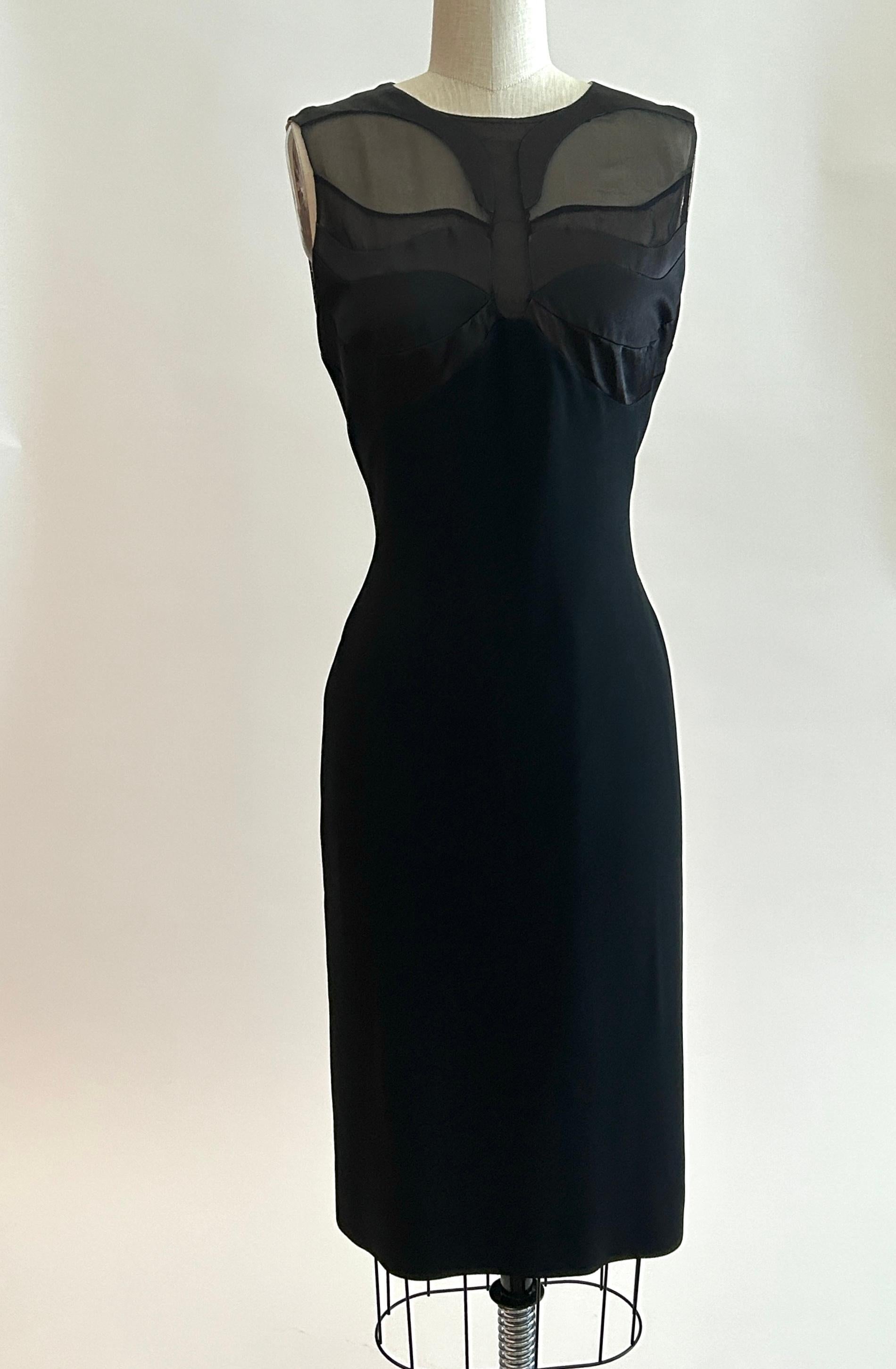 Alexander McQueen black pencil dress with multi-toned black satin, mesh and sheer panels at bust creating a butterfly. Nude lining. Back zip and hook and eye closure. 

50% viscose, 40% acetate, 10% silk. 
Lined in a light weight nude fabric (feels