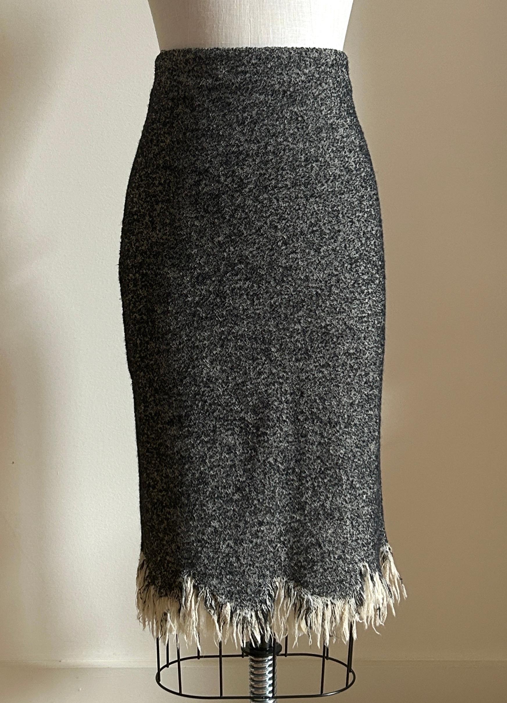 Alexander McQueen 2010 skirt in cream and black nubby herringbone tweed. Distressed hem with cream chiffon pleated ruffles at trim. Back zip and hook and eye. 

Fabric 1: 49% wool, 34% fleece wool, 17% polyamide. 
Fabric 2: 100% silk.  
Fully lined