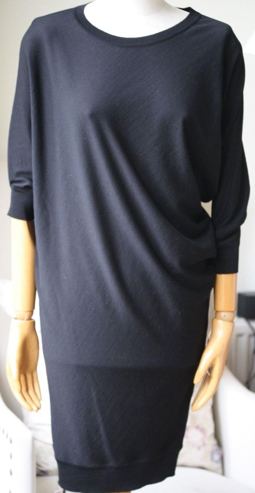 Alexander McQueen's asymmetric sweater dress has been crafted in Italy from soft mid-weight wool. This dolman-sleeve style will work day or night. Black mid-weight wool. Asymmetric dolman sleeves, ribbed trims. Slips on. 100% wool. Designer colour: