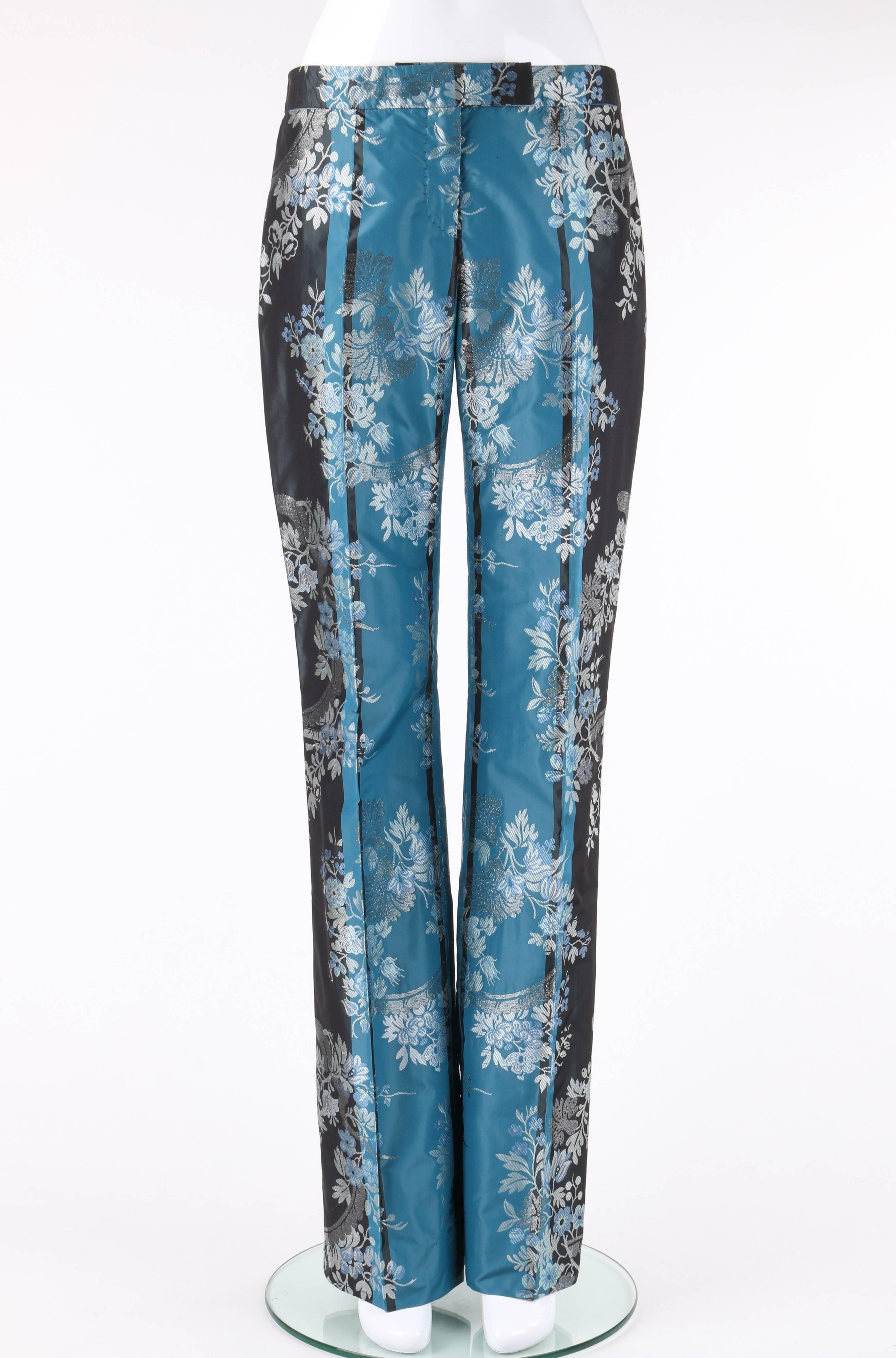 Alexander McQueen Autumn/Winter 2002 two tone floral brocade pants. From Alexander McQueen's Supercalifragilistic collection. Two tone teal and charcoal gray silk floral silk brocade. Thin banded waist. Center front zip fly with single exterior hook