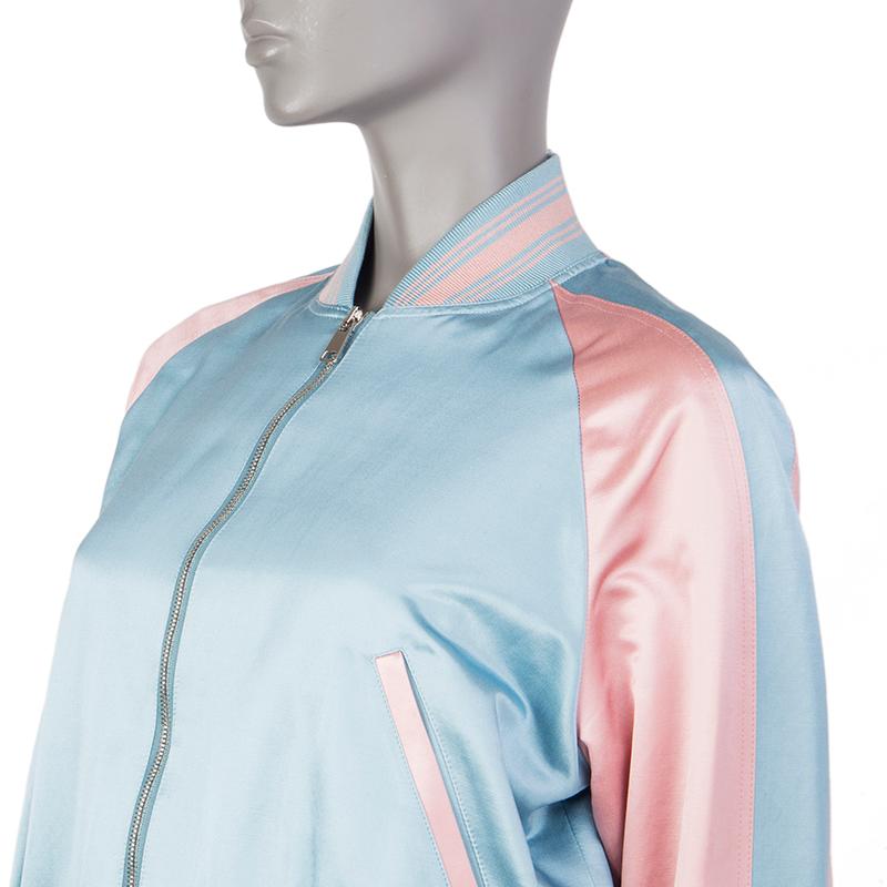 Alexander McQueen embroidered varsitiy jacket in baby blue and baby pink cotton (75%) and silk (25%). With two pockets on the front, knit details in cotton (90%), nylon (8%), and elastane (2%), and embroidery on the back in silver, black, and red