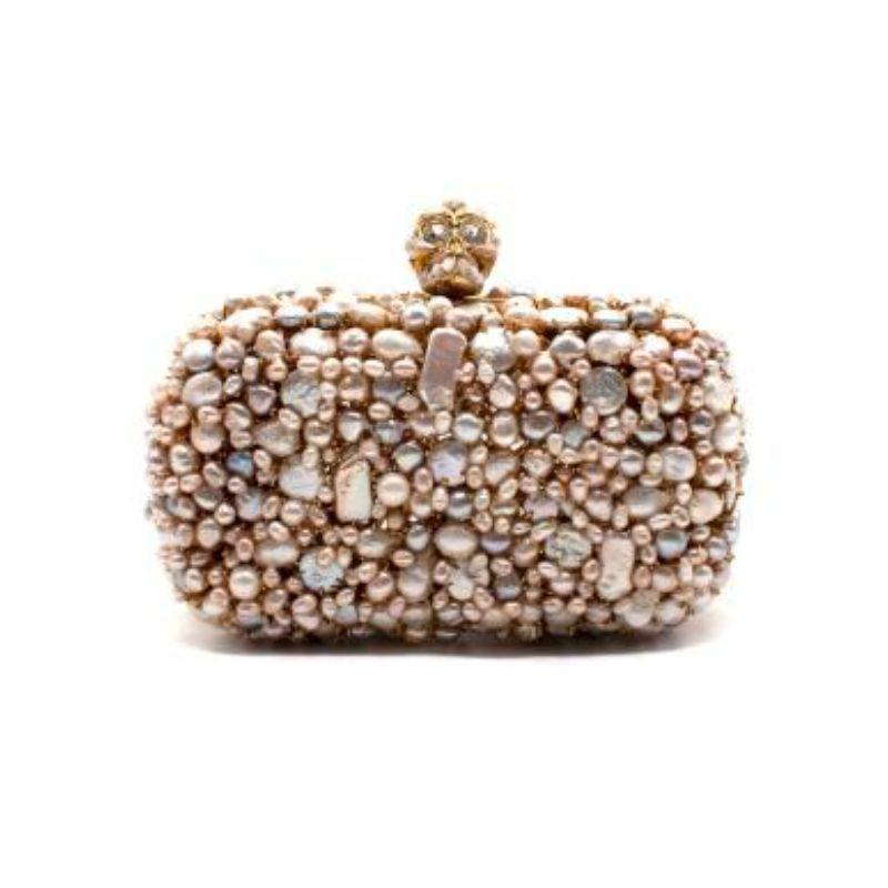 Alexander McQueen Pearlescent Skull Clutch Bag

- Faux pearl body 
- Crystal and faux pearl skull fastening 
- Rectangular body 
- Nude leather interior 
- Push clasp fastening 
- Heavy weight

Materials:
Faux pearl
metal
leather

Made in Italy