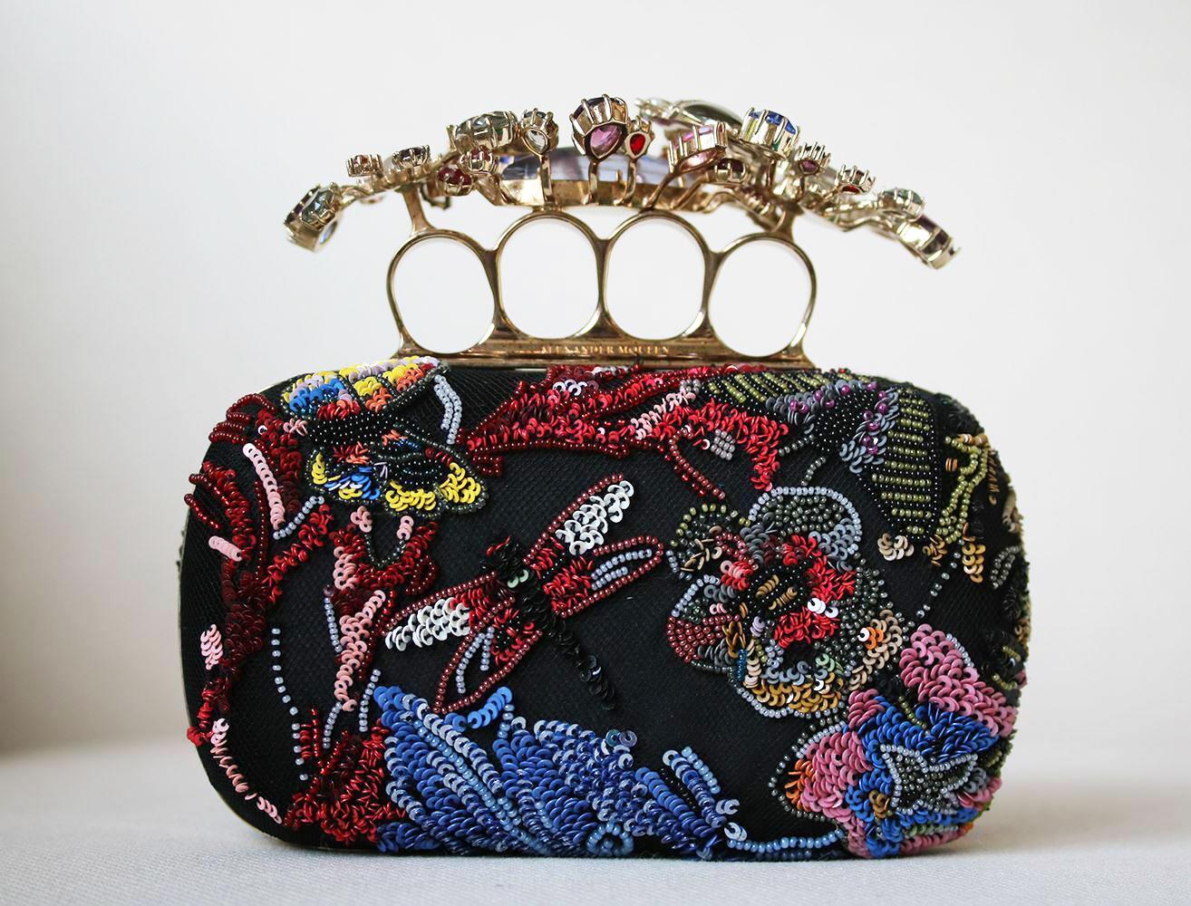 Multicolour beaded wonderland embroidery Short Knuckle Clutch. Features Swarovski crystal floral knuckle holder. Tulle and silk-satin body of the clutch and a chain strap. Brass hardware with a gold finish. Leather lining. 80% Brass, 20% satin. Does