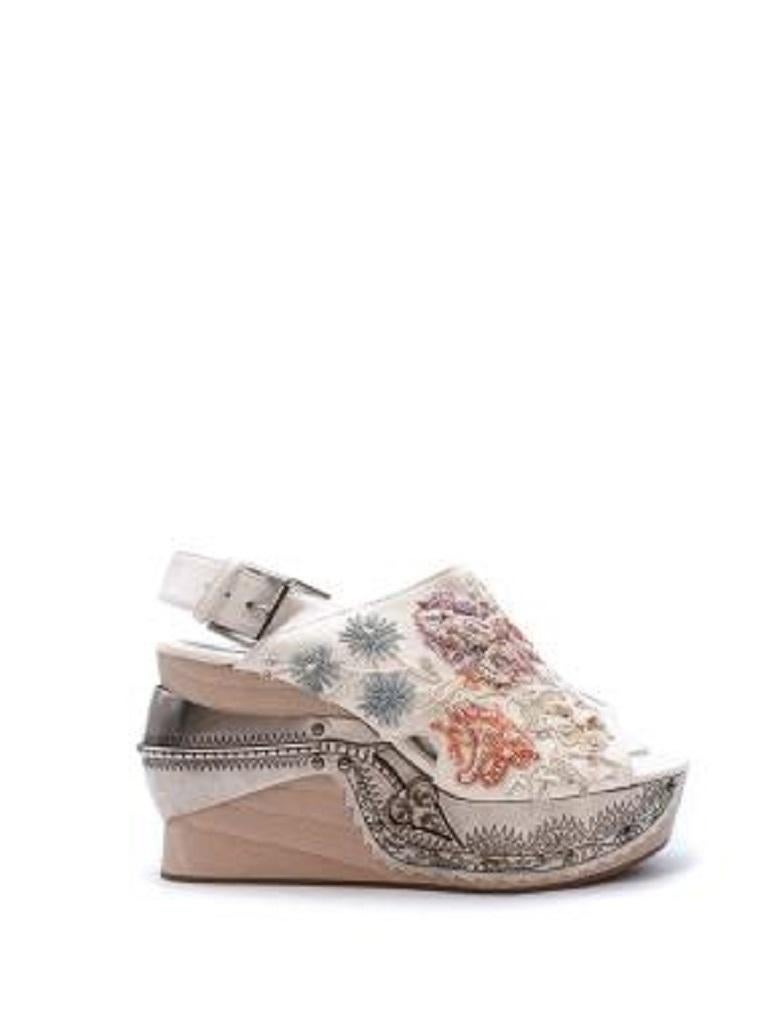 Alexander McQueen Beaded Ivory Suede Metal & Wooden Heeled Sandals
 
 - Peep toe, slingback suede upper with floral beadwork
 - Set on a high wooden platform with aged silver-tone metal plaque
 
 Materials:
 Suede 
 Wood 
 
 PLEASE NOTE, THESE ITEMS