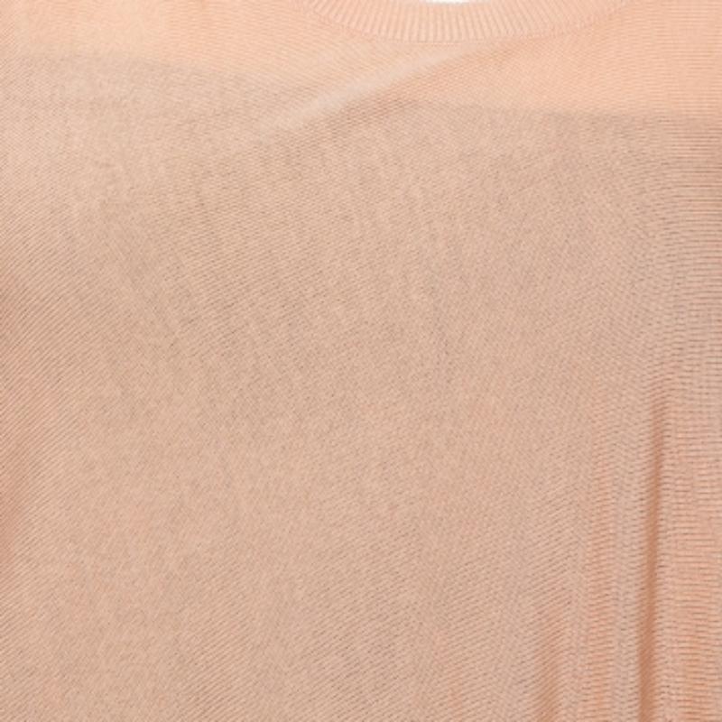 Enliven up your daily style with this Alexander McQueen top. It features a draped design through one of the shoulders, creating an asymmetric sleeve, a chic element that makes the top ultra-stylish. Wear this long, beige-hued top with fitted jeans