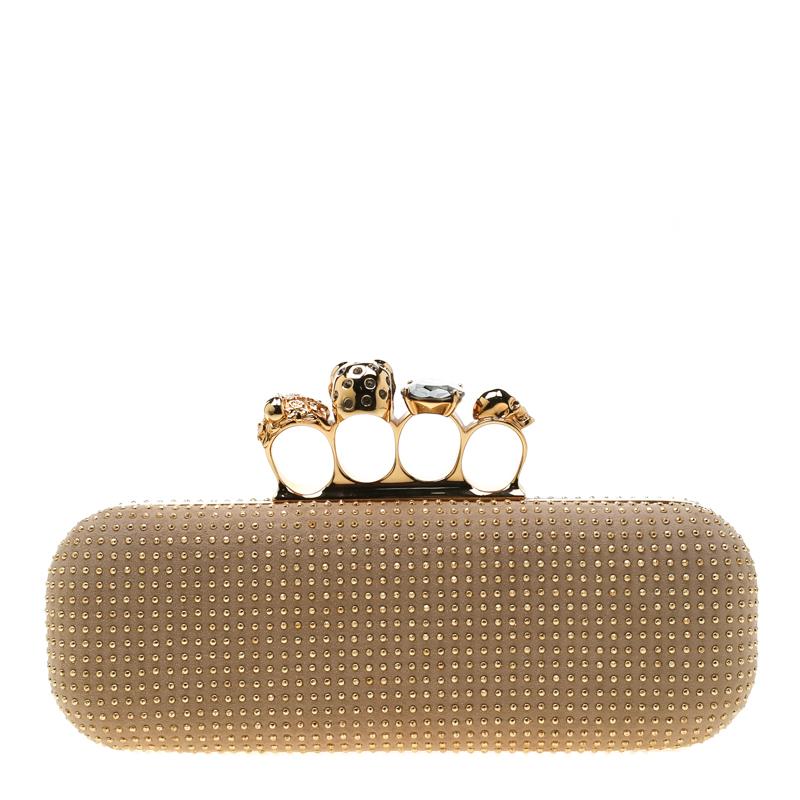 This Knuckle Clutch from Alexander McQueen exudes versatility and luxury. Crafted from beige nubuck leather, it features gold-tone stud embellishments on the exterior and a well-sized interior. This piece is complete with the brand's iconic