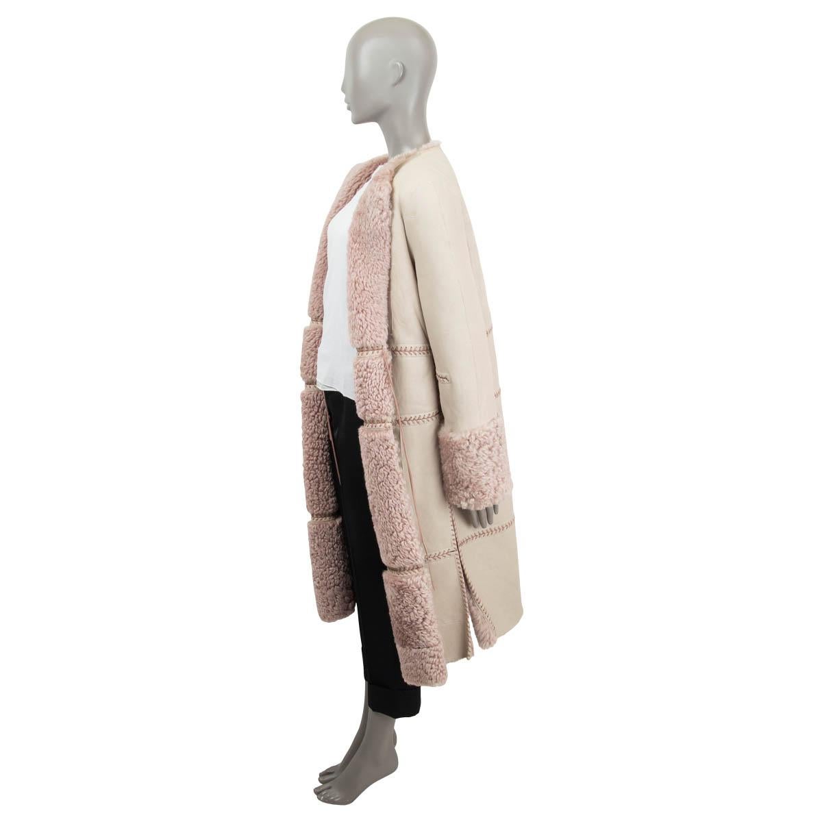 100% authentic Alexander McQueen open shearling coat in sand and dusty rose dyed lamb leather and shearling (100%). Features leather fringes and slits on the sides. Has a barely visible open seam on the back, otherwise in excellent