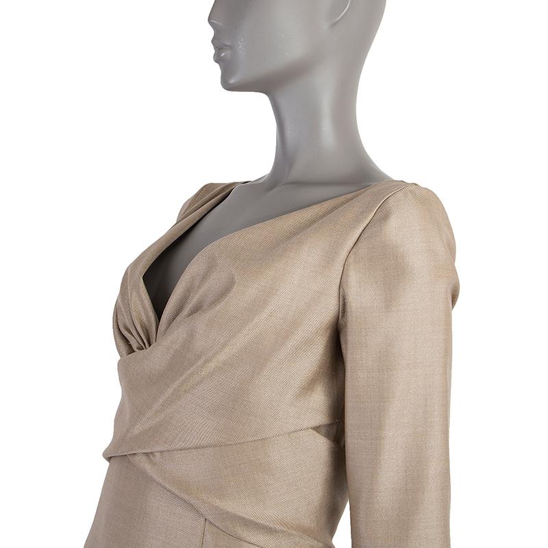 Alexander McQueen 3/4-sleeve dress in shimmering beige wool (55%), silk (40%), polyamide (4%) and elastane (1%). Opens with zipper on the back. Lined in beige acetate (52%) and viscose (48%). Has been worn and is in excellent condition.

Tag Size