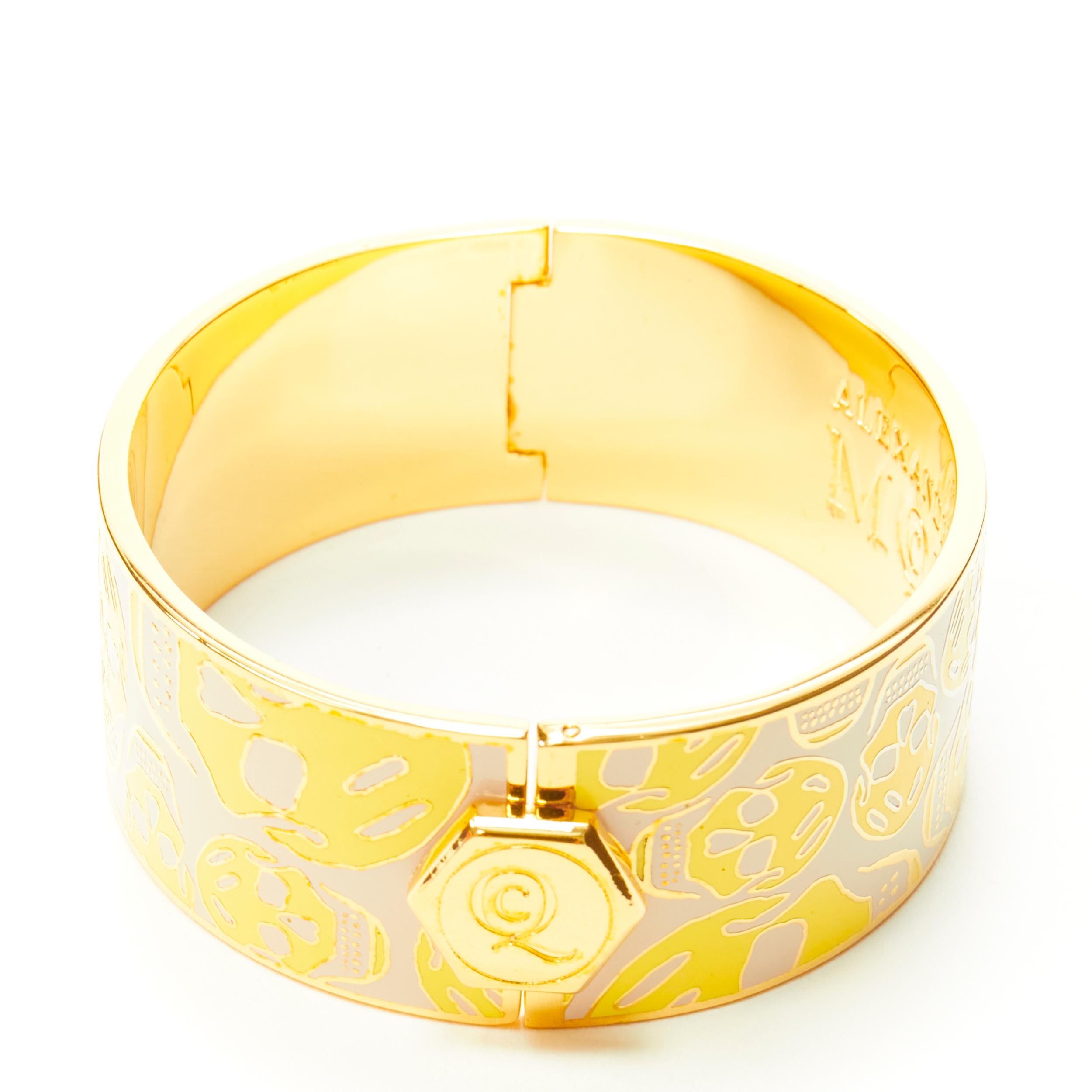 ALEXANDER MCQUEEN beige yellow skull enamel gold tone brass bangle cuff 
Reference: ANWU/A00146 
Brand: Alexander McQueen 
Material: Brass 
Color: Yellow 
Pattern: Skull 
Closure: Push clasp 
Extra Detail: MCQ logo button hinged bangle. 
Made in: