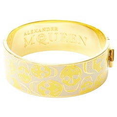 ALEXANDER MCQUEEN beige yellow skull enamel gold tone brass bangle cuff
